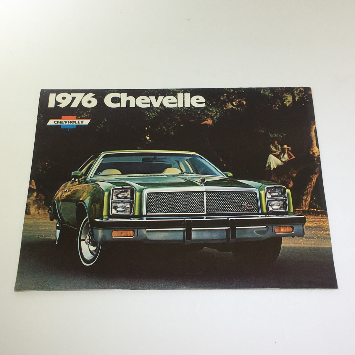 Vintage 1976 Chevelle Malibu Classic Sedan/Coupe S-3 V-8 Car Catalog Brochure featuring a green Chevelle parked outdoors, showcasing its classic design.