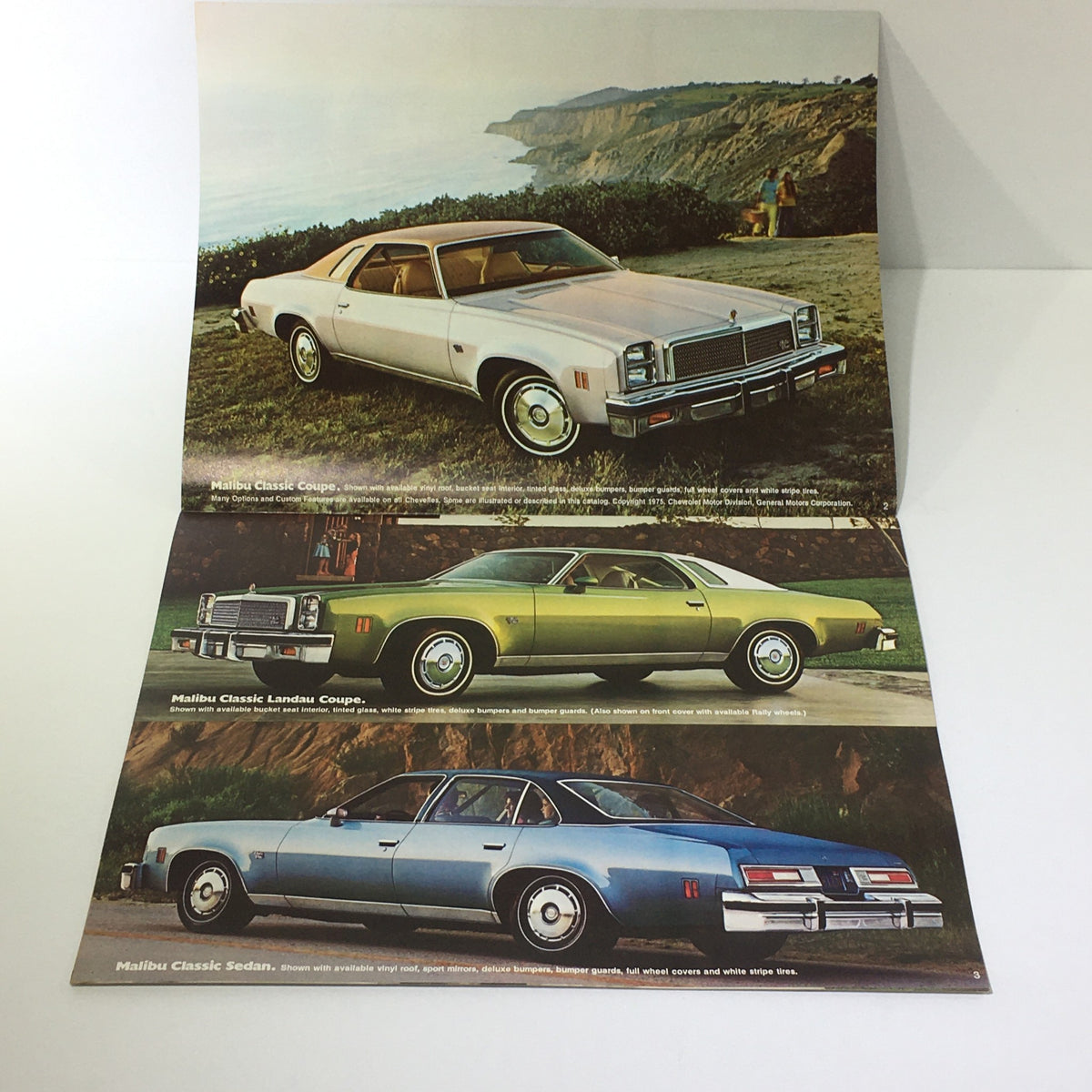 Vintage 1976 Chevelle Malibu Classic Sedan/Coupe S-3 V-8 Car Catalog Brochure showcasing the Malibu Classic Coupe, Landau Coupe, and Sedan with stunning coastal background.