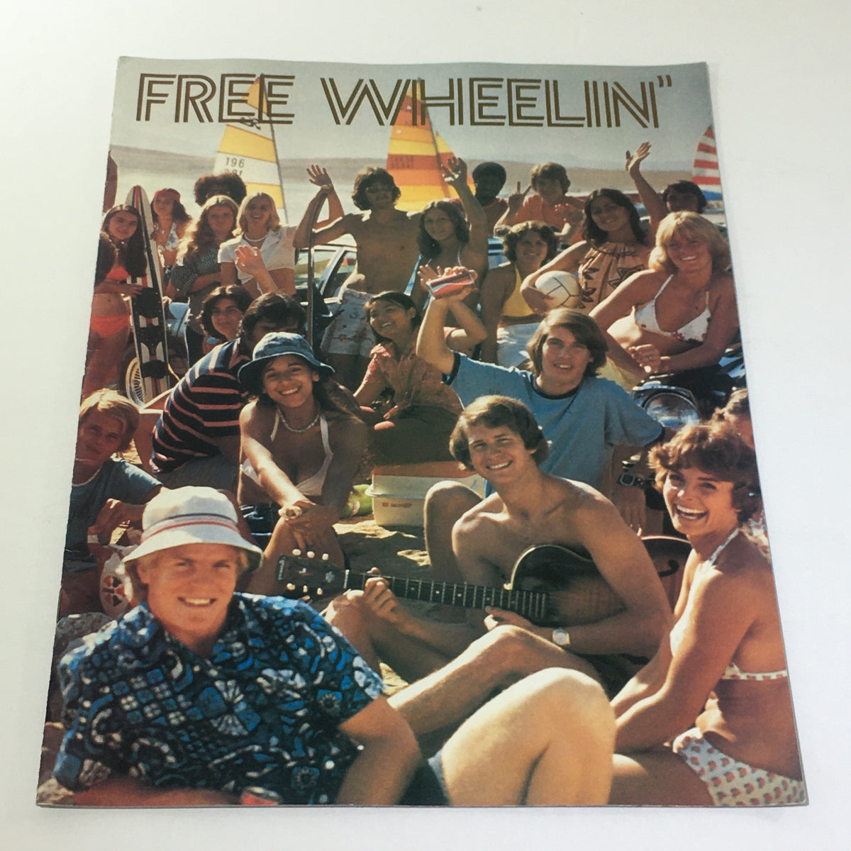 Vintage Free Wheelin' Mustang II MPG 2+2 Stallion - 1965 Shelby Cobra Car Brochure featuring a beach scene with a group of young people enjoying summer activities.