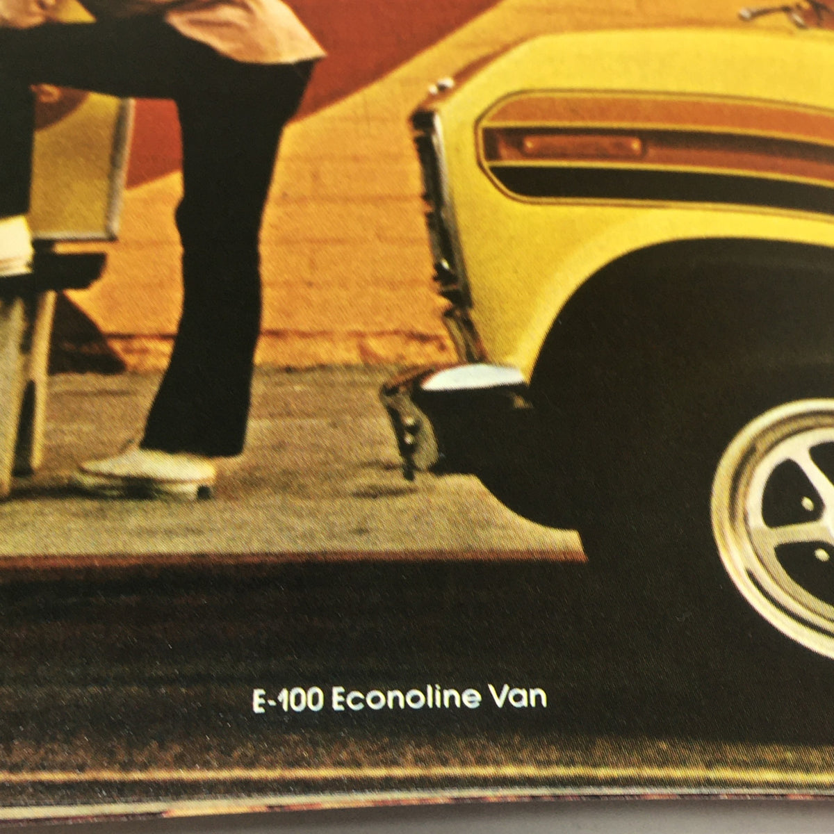 Vintage Free Wheelin' Mustang II MPG 2+2 Stallion - 1965 Shelby Cobra Car Brochure with an image of a bright yellow E-100 Econoline Van, highlighting classic American van design.