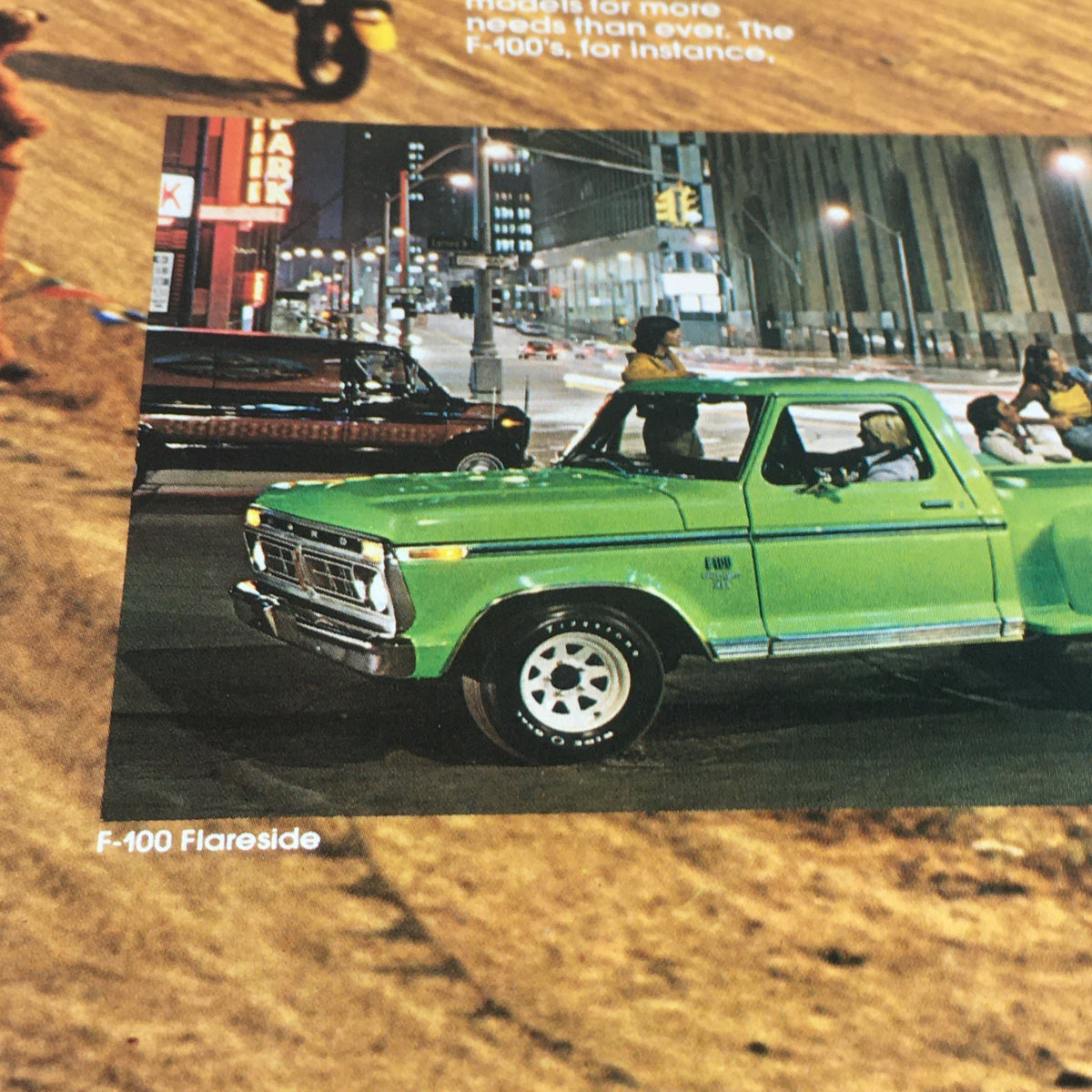 Vintage Free Wheelin' Mustang II MPG 2+2 Stallion - 1965 Shelby Cobra Car Brochure showcasing a classic green Ford F-100 truck parked at night.