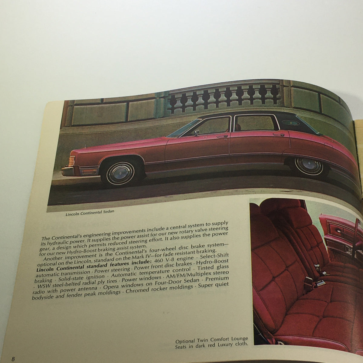 Vintage Lincoln-Mercury 1975 - Continental Sedan 460 V-8 Engine Car Brochure interior page showcasing the Lincoln Continental Sedan with a description of its features and luxurious twin comfort lounge seats.