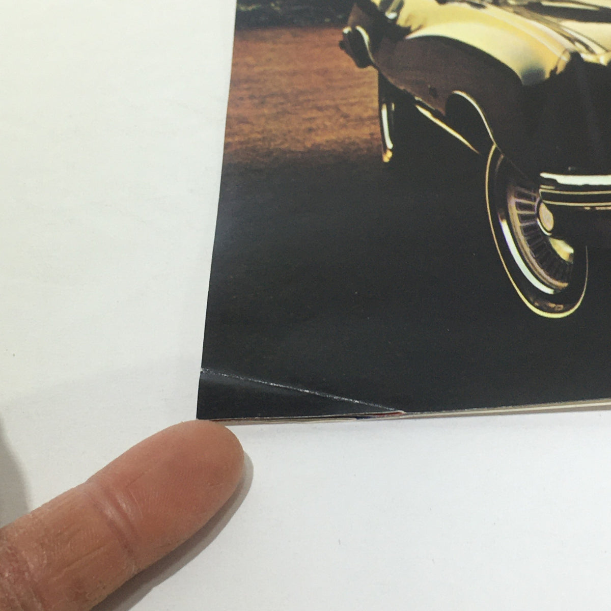 Close-up view of the 1976 Monte Carlo Landau Coupe by Chevrolet brochure showing minor wear, emphasizing its vintage condition.