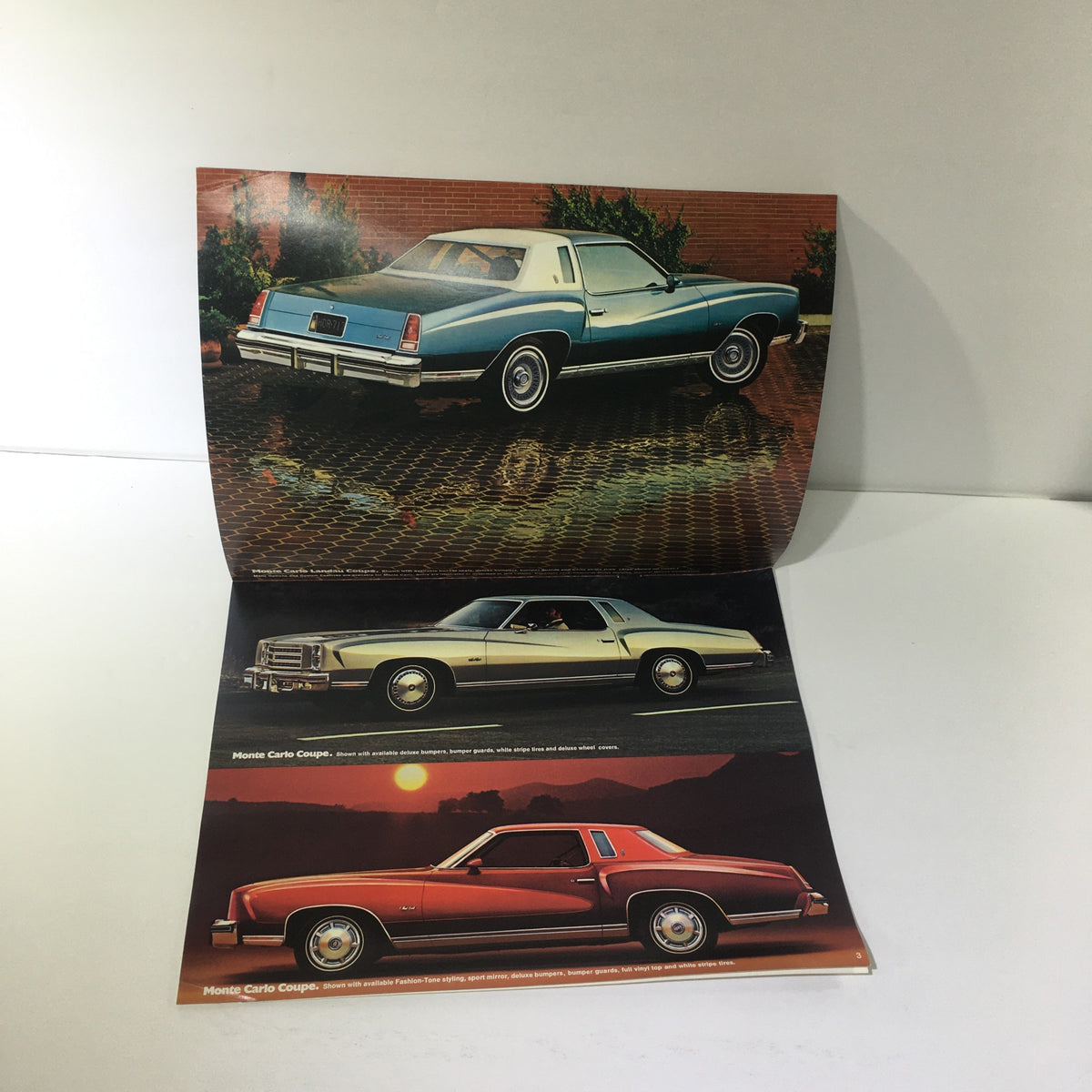Open vintage brochure for the 1976 Monte Carlo Landau Coupe by Chevrolet showcasing multiple angles of the car in a colorful layout.