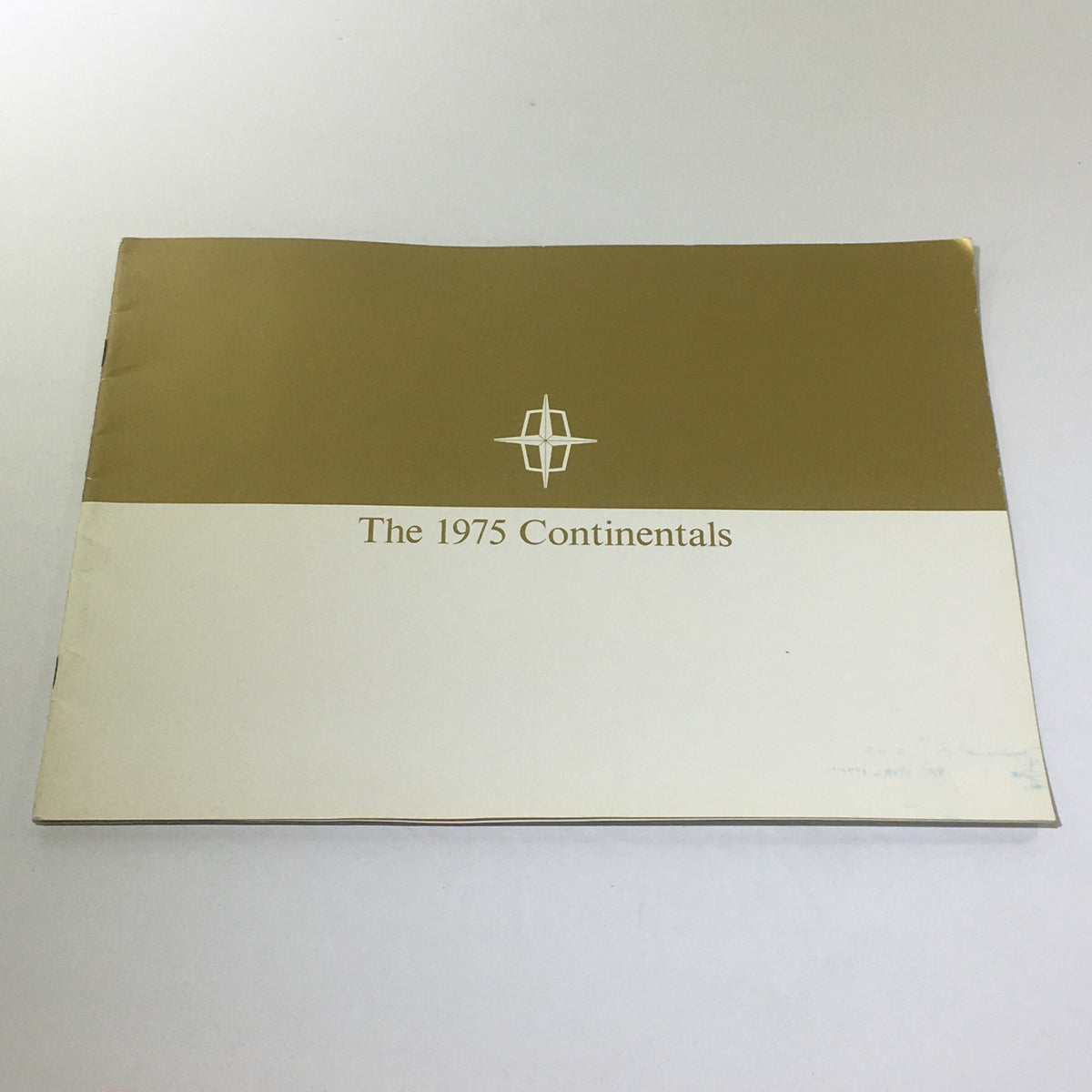 Cover of the Vintage The 1975 Continentals Town Coupe/Town Car/Mark IV Car Catalog Brochure showcasing its elegant design with a gold and white color scheme.