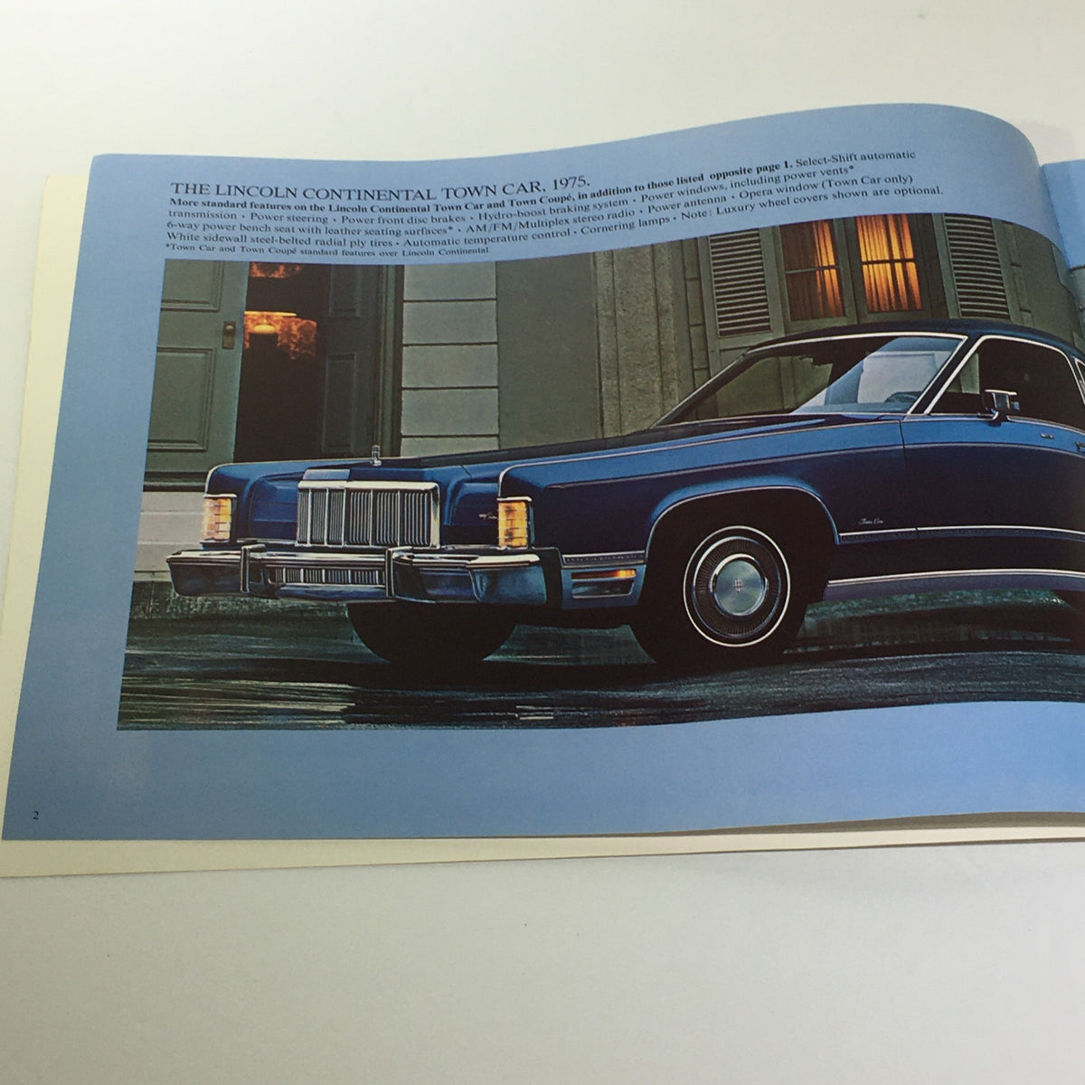 Interior page of the Vintage The 1975 Continentals Town Coupe/Town Car/Mark IV Car Catalog Brochure displaying the Lincoln Continental Town Car in blue, highlighting its luxurious design.