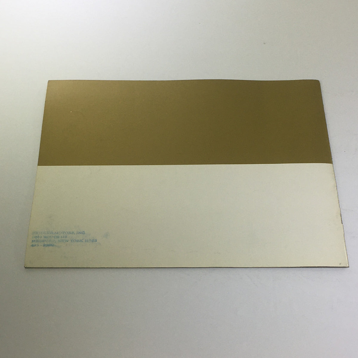 Back cover of the Vintage The 1975 Continentals Town Coupe/Town Car/Mark IV Car Catalog Brochure with a gold and white design.