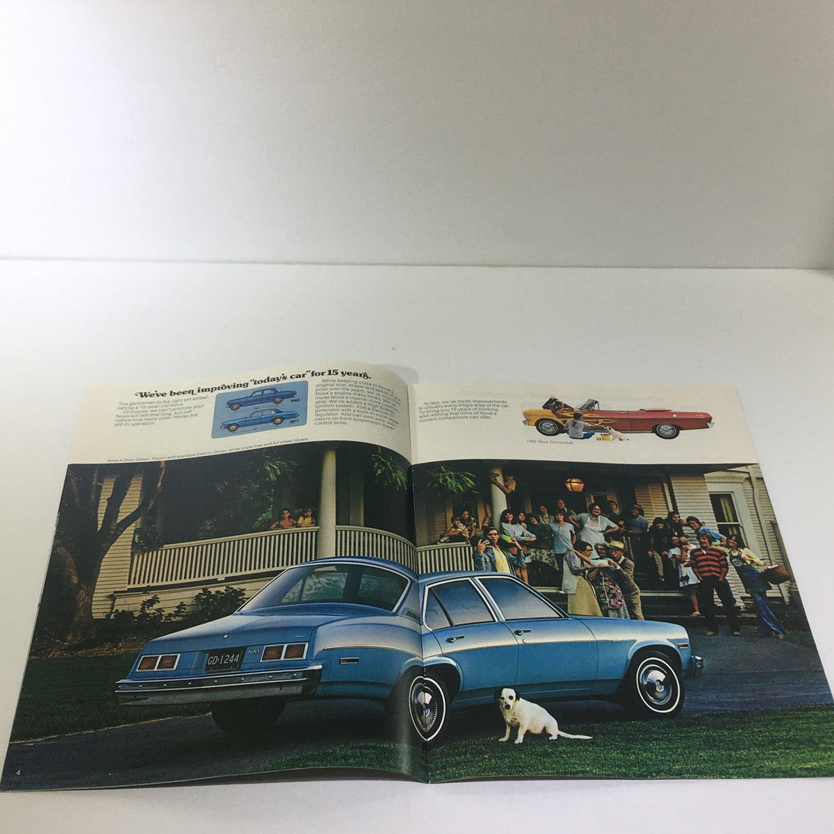 Inside spread of Vintage 1977 Nova Chevrolet 4-Door Hardtop 350-4 V-8 Engine Car Catalog Brochure showcasing a family and a blue 1977 Nova parked outside a house.