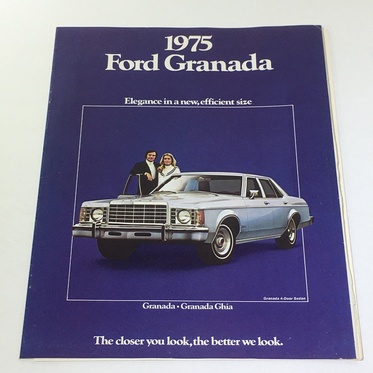 Vintage 1975 Ford Granada brochure featuring a blue 4-door sedan with a couple standing by it, highlighting elegance in a new, efficient size.