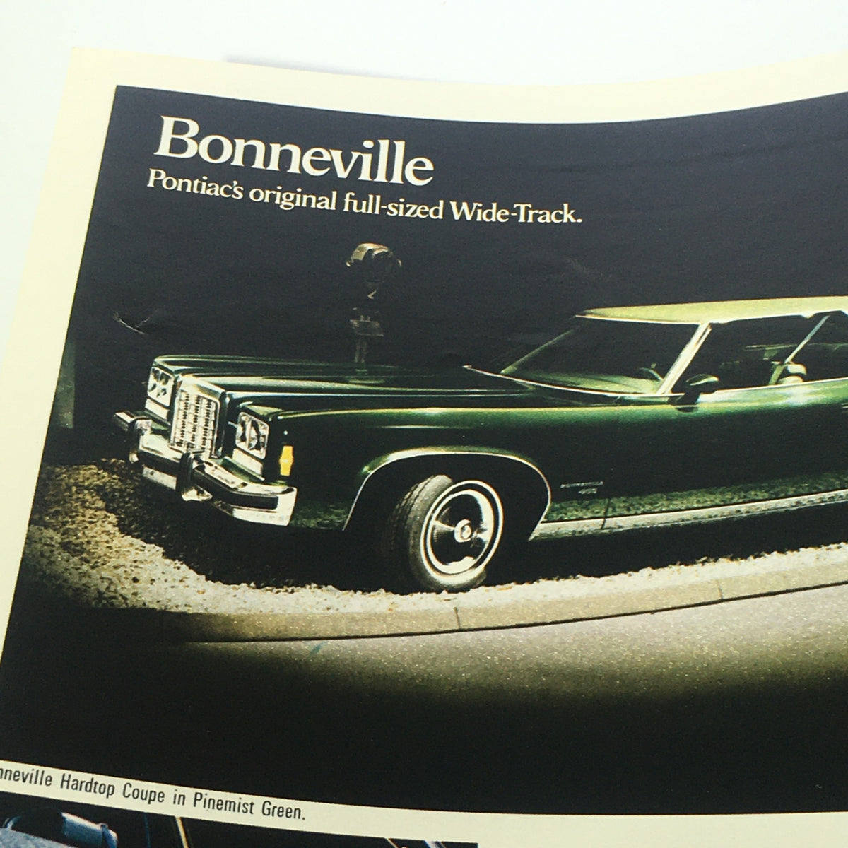1974 Pontiac Grand Ville 4-Door Hardtop V-8 Sedan Car Auto Catalog Brochure highlighting a green Bonneville, Pontiac's original full-sized Wide-Track luxury vehicle.
