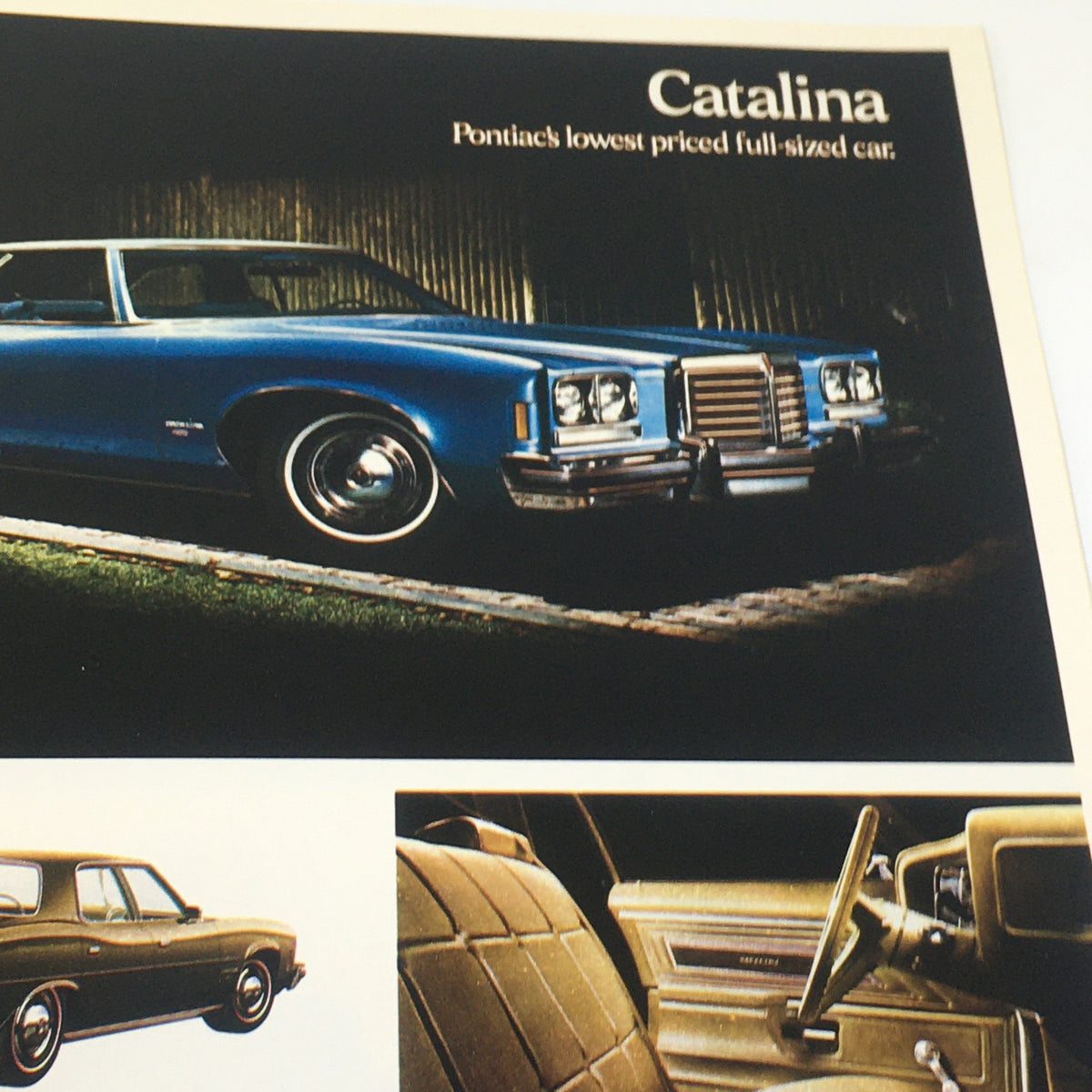 1974 Pontiac Grand Ville 4-Door Hardtop V-8 Sedan Car Auto Catalog Brochure presenting a blue Catalina, noted as Pontiac's lowest priced full-sized car.