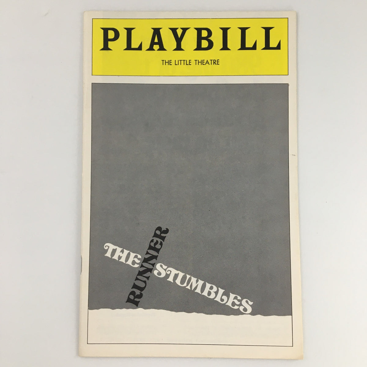 1976 Playbill for The Runner Stumbles at The Little Theatre, featuring a minimalist gray cover with bold text.