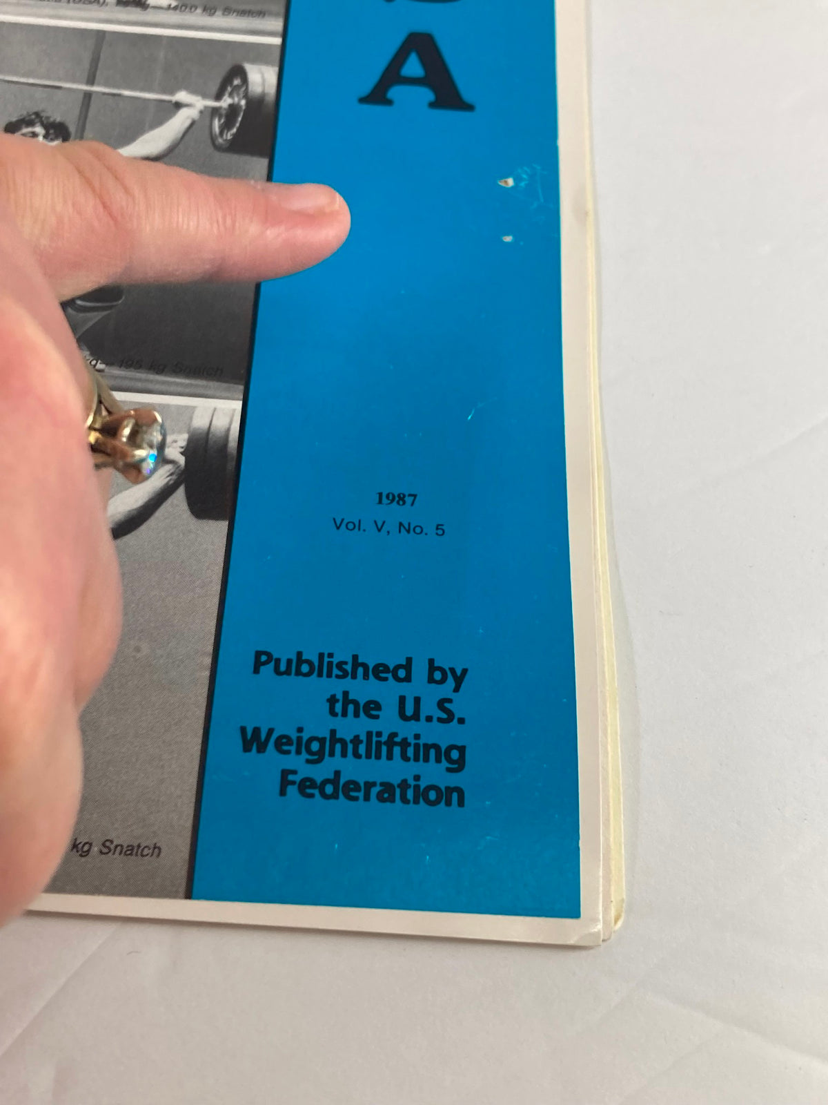 Close-up of the 1987 VTG Weightlifting USA Magazine cover showing Volume 5, Number 5, published by the U.S. Weightlifting Federation, featuring a description of Karyn Marshall.