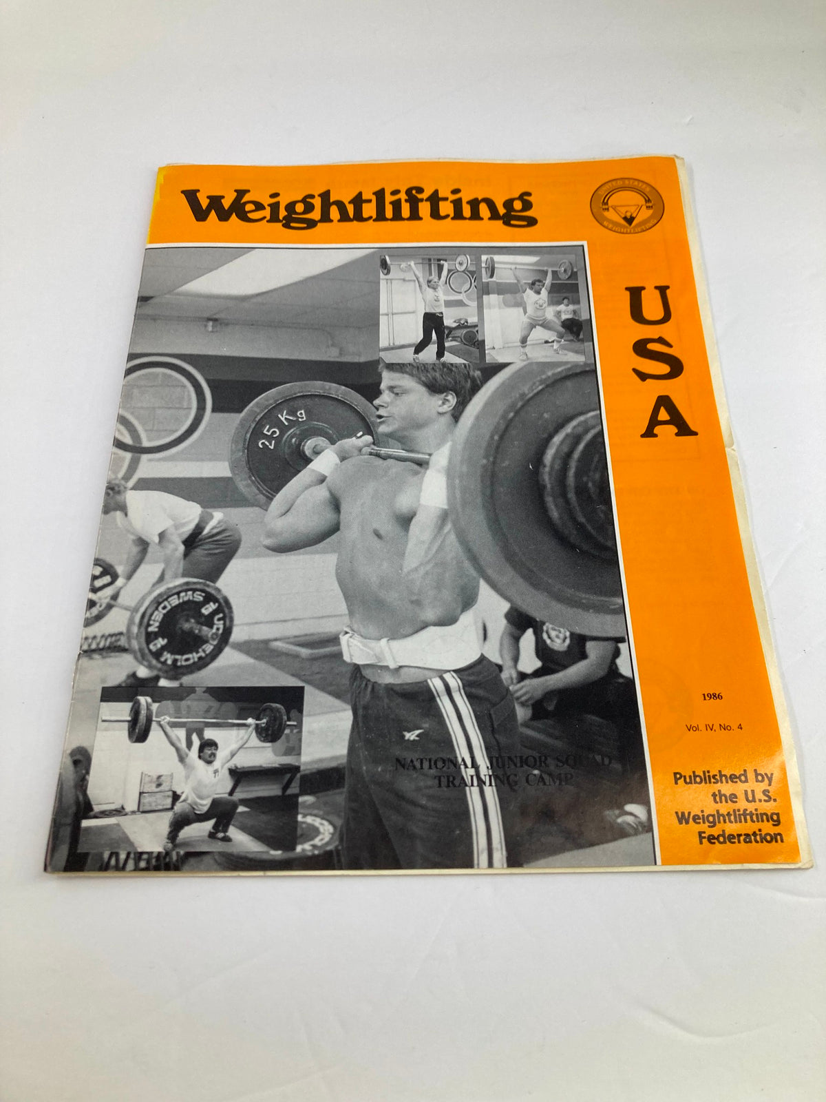 Cover of VTG Weightlifting USA Magazine 1986 Vol 4 #4 featuring a weightlifter in action, showcasing the vibrant orange theme and photographs of athletes in training.