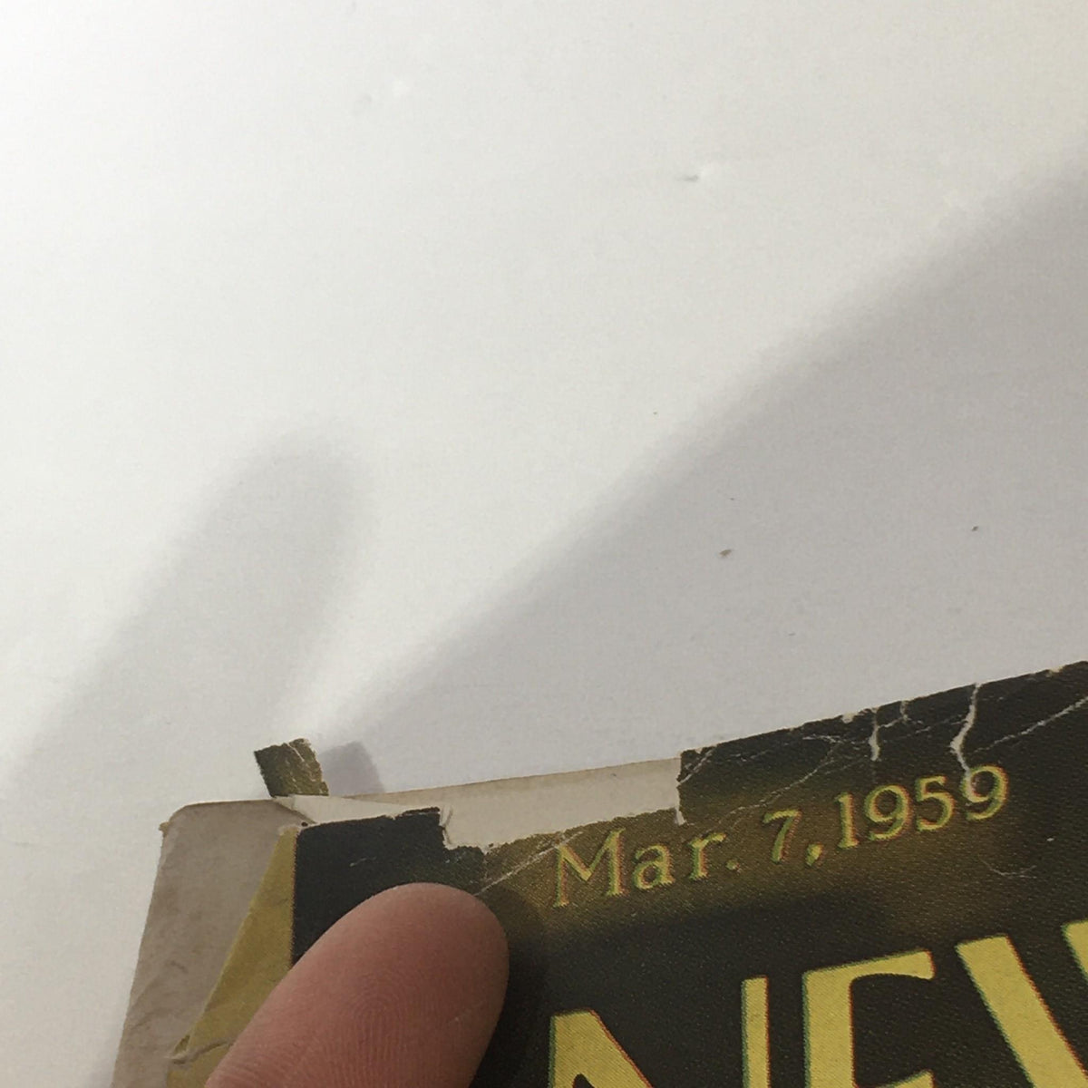 Top view of The New Yorker: March 7, 1959 magazine displaying the date and worn edges.