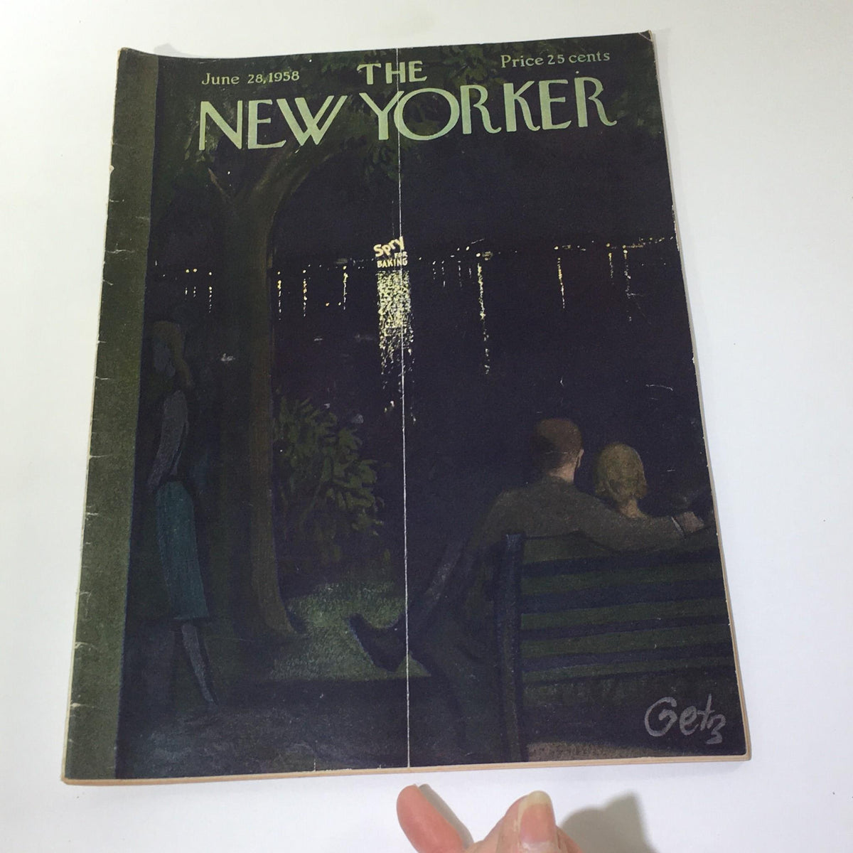 Close-up view of The New Yorker magazine from June 28, 1958, by Arthur Getz, highlighting a couple on a park bench with a picturesque reflection on the water, emblematic of vintage American art.