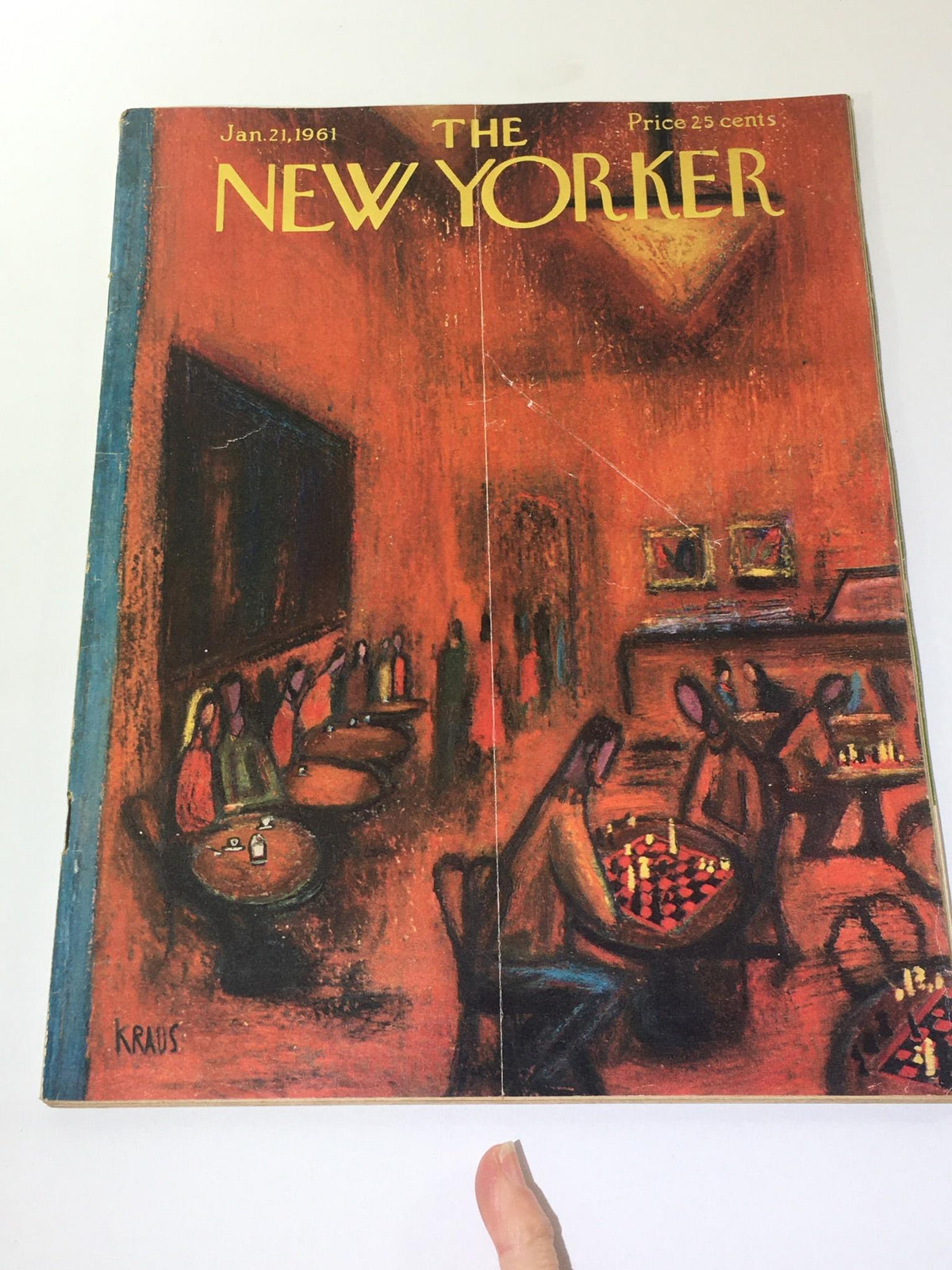 Cover of The New Yorker magazine from January 21, 1961, featuring an artistic illustration by Robert Klaus. The cover depicts a vibrant scene in a café with patrons engaged in social activities, capturing the essence of early 1960s culture.