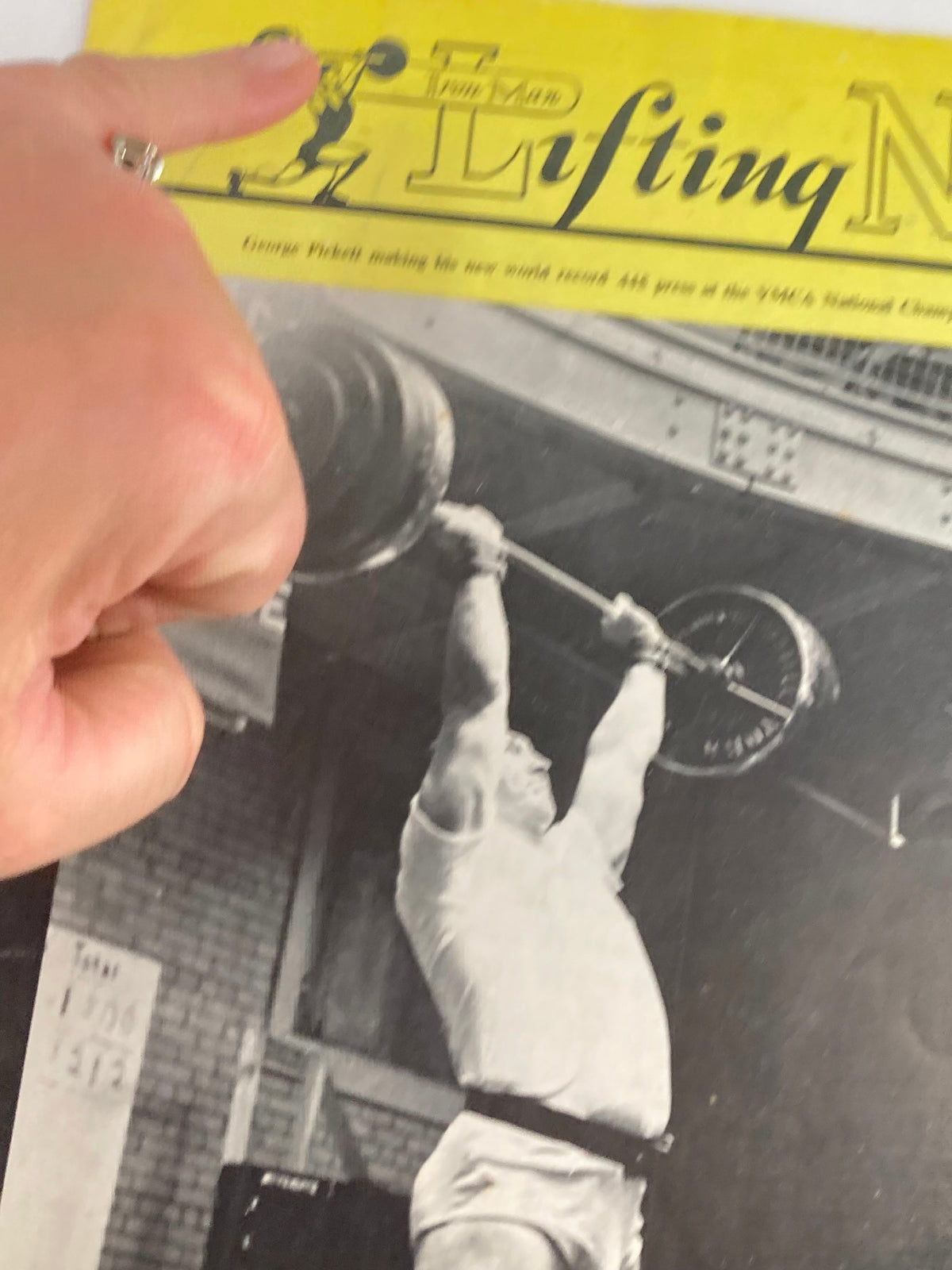 Close-up of VTG Iron Man Lifting News Vol 14 #7 May 1968 cover showing George Pickett lifting weights, highlighting the magazine's unique design and historical significance.