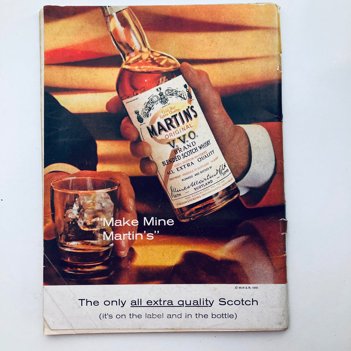 Vintage advertisement for Martin's Scotch Whisky, highlighting the brand's quality with a captivating slogan 'Make Mine Martin's'.