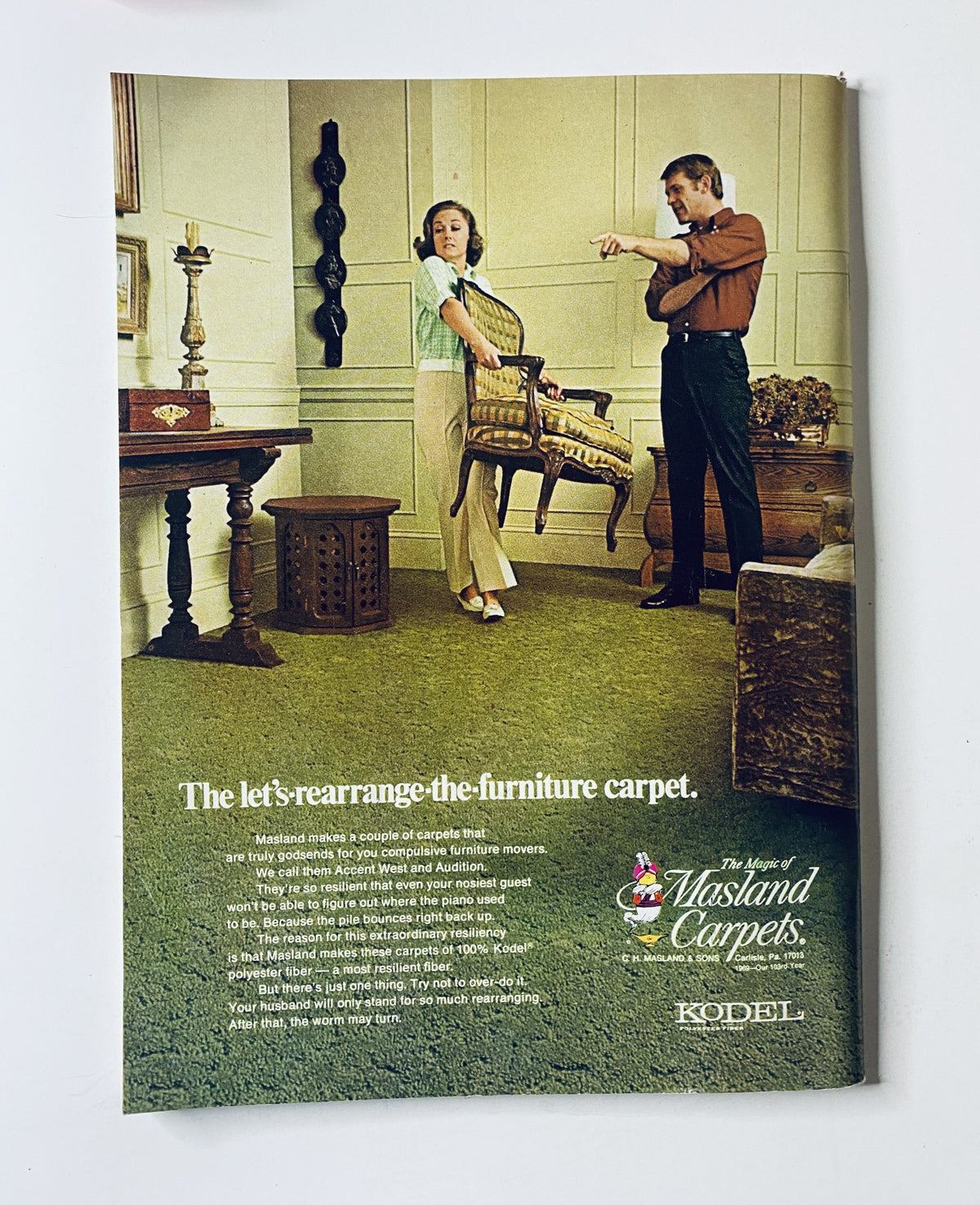 Advertisement for Mastland Carpets featured in The New Yorker Magazine June 7, 1969, showcasing a woman arranging furniture on a carpet with a man pointing.