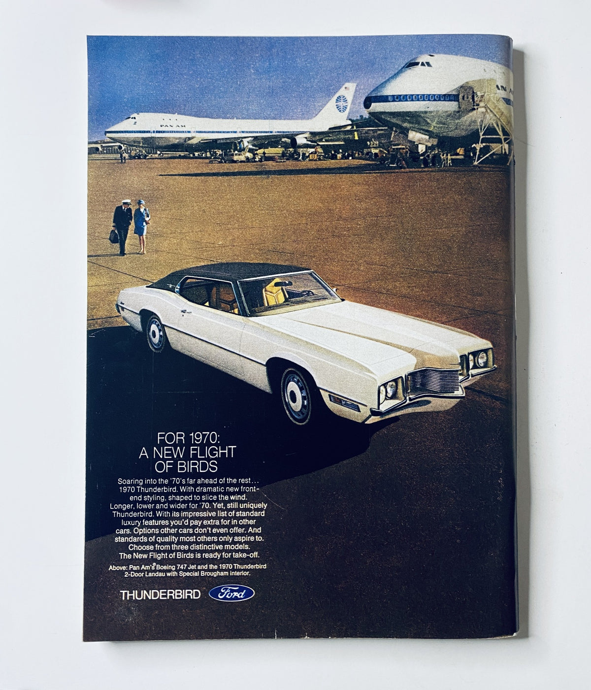 Advertisement from The New Yorker Magazine November 22, 1969, featuring a Ford Thunderbird car in front of a supersonic transport airplane. Promoting the Ford Thunderbird model for 1970 with the tagline 'A New Flight of Birds'.