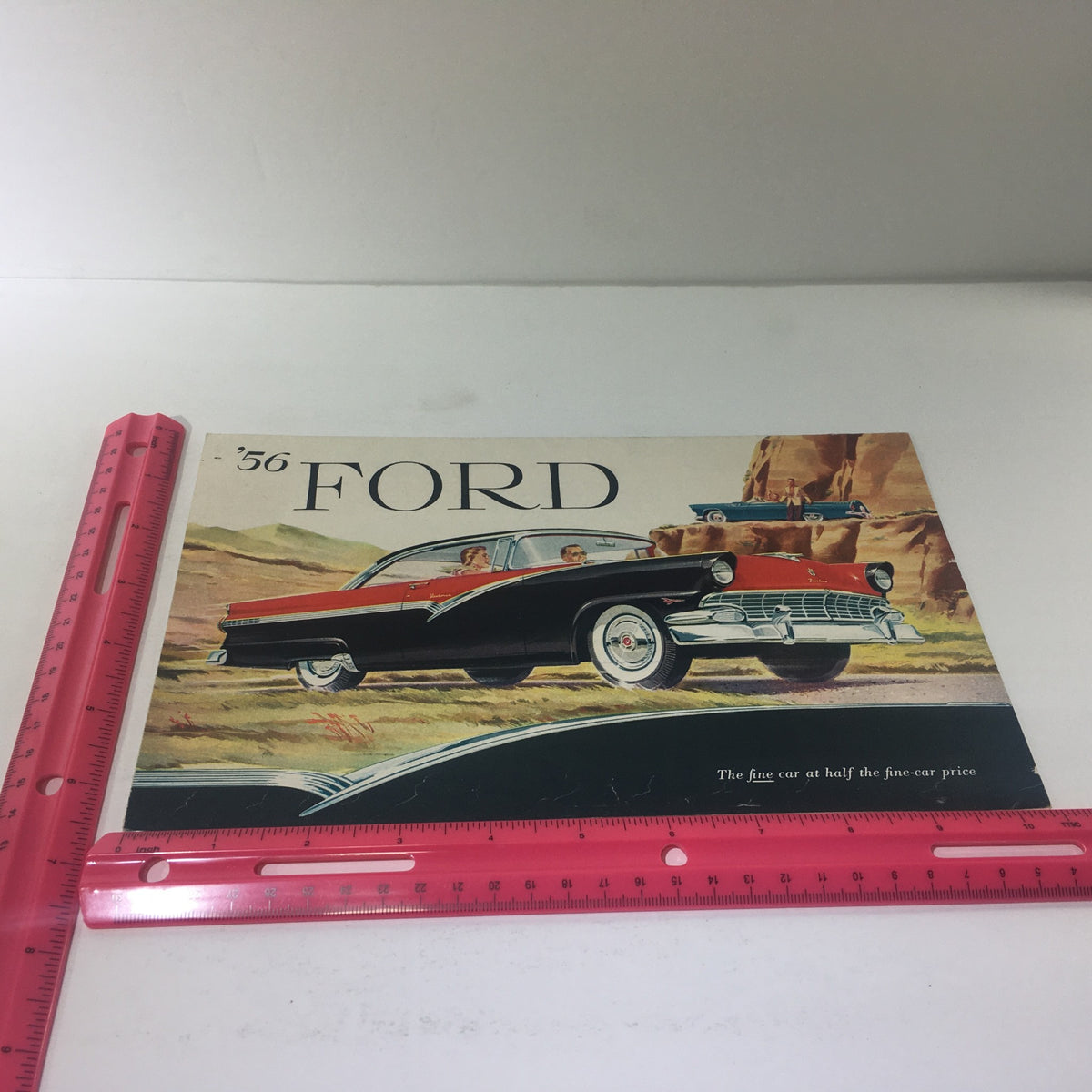 1956 Ford Thunderbird Y-8 Power Double-Swivel Lifeguard Mirror Car Catalog cover displaying the Ford car in a scenic landscape, emphasizing the tagline 'The fine car at half the fine-car price'.