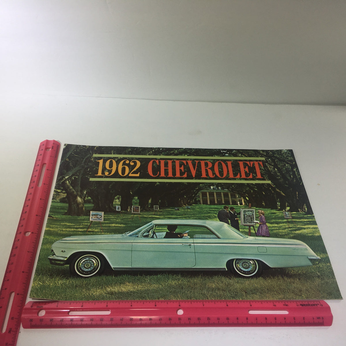 1962 Chevrolet Impala Super Sport Coupe Turbo-Fire 283 V-8 Engine car catalog displayed with a picturesque background, showcasing the classic design and style of the vehicle, ideal for collectors and automotive enthusiasts.