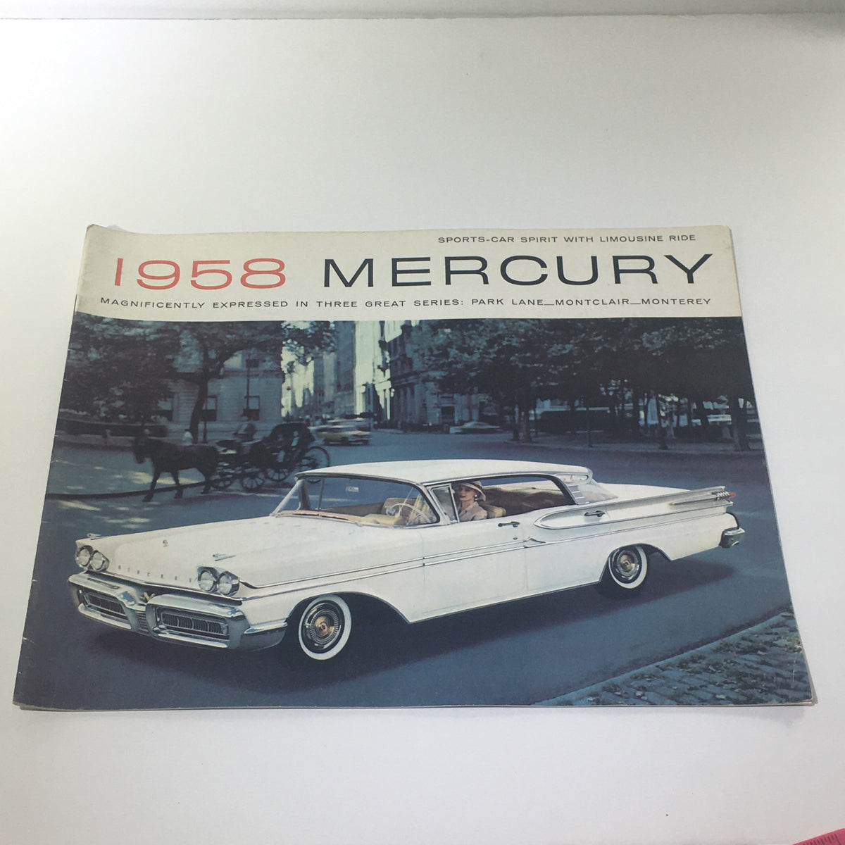 1958 Mercury Monterey Montclair Park Lane Convertible Marauder Car Catalog cover featuring a classic white convertible car on a city street.