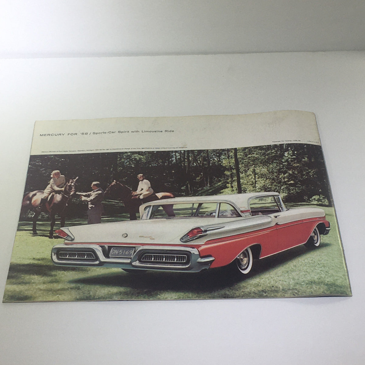 Image from the 1958 Mercury Monterey Montclair Park Lane Convertible Marauder car catalog, showcasing a Mercury car parked in a scenic outdoor setting.