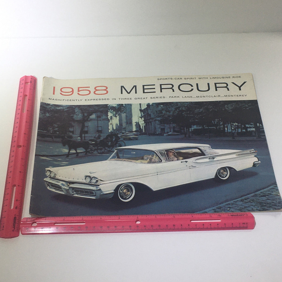 Cover image of the 1958 Mercury Monterey Montclair Park Lane Convertible Marauder car catalog, featuring a classic Mercury car being driven through a city street.