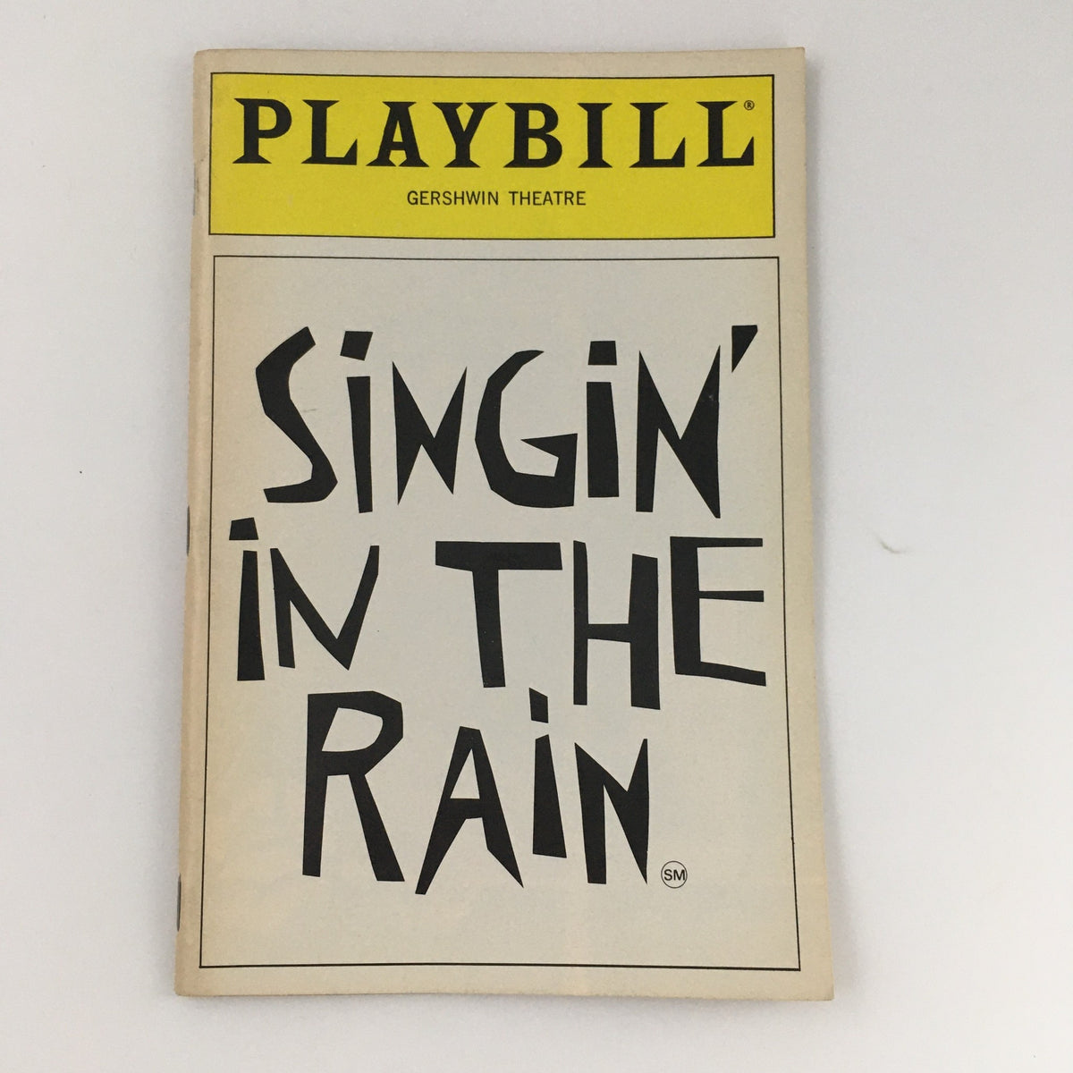 1985 Playbill for 'Singin' in the Rain' at Gershwin Theatre featuring the title prominently displayed.