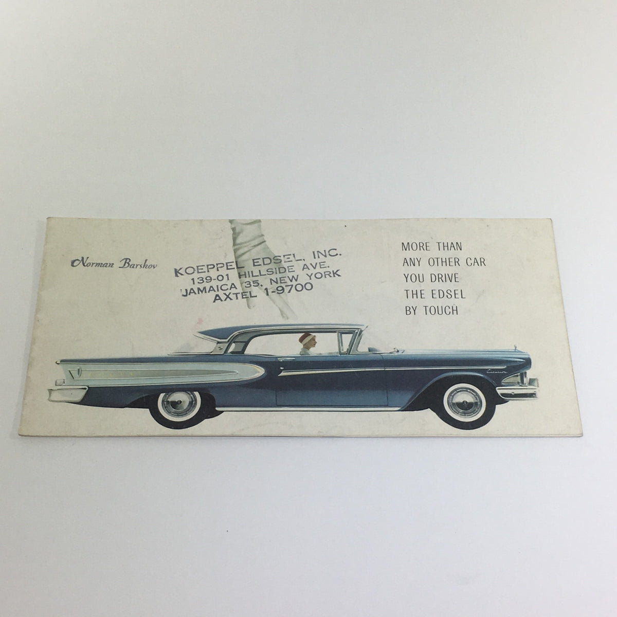 Vintage 1958 Ford Edsel Car dealer Catalog Brochure featuring a side view illustration of the Edsel with a figure inside. The brochure emphasizes the slogan 'More than any other car you drive the Edsel by touch.'