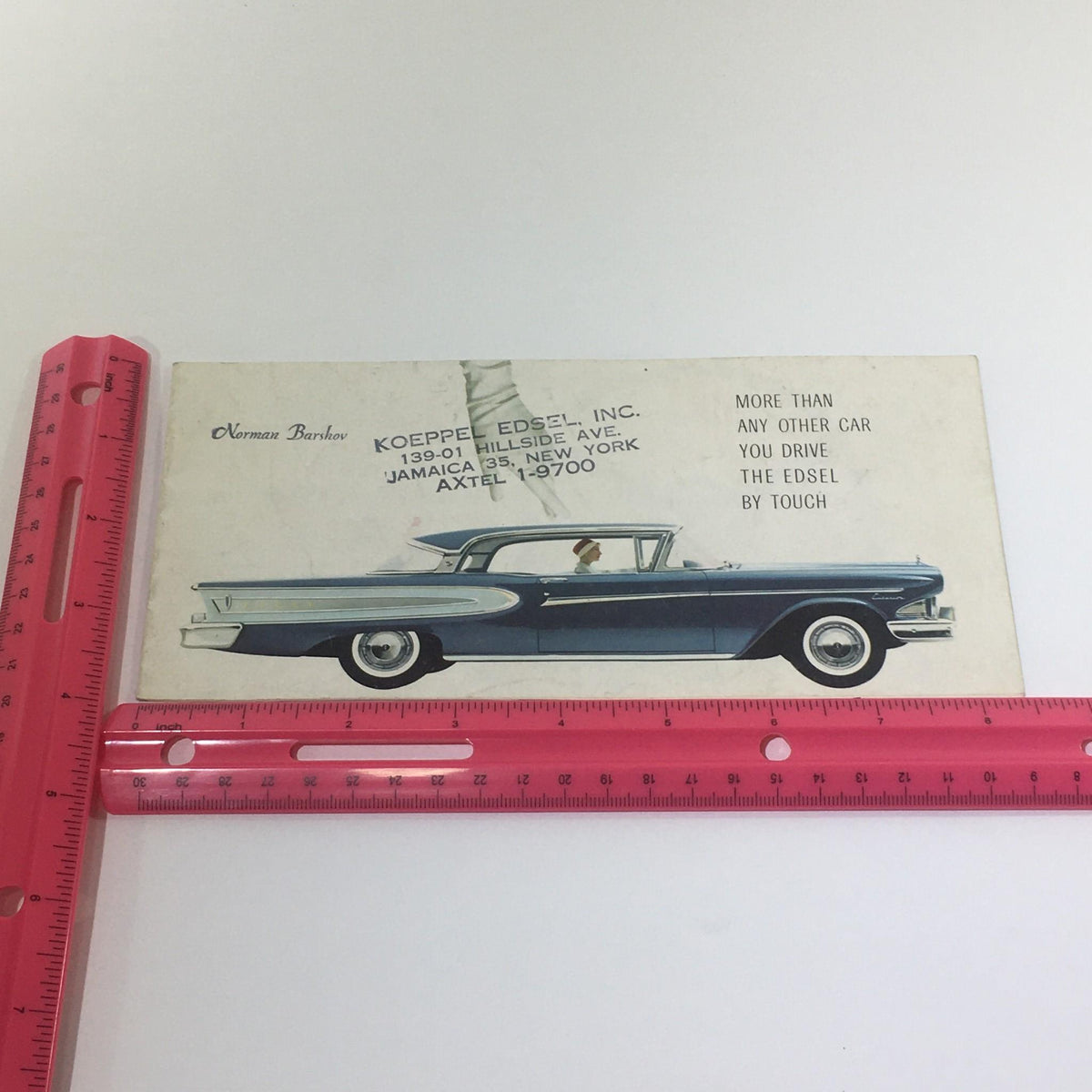 Vintage 1958 Ford Edsel Car dealer Catalog Brochure displayed next to a ruler for size reference, showcasing the front cover and detailing the dealership information.