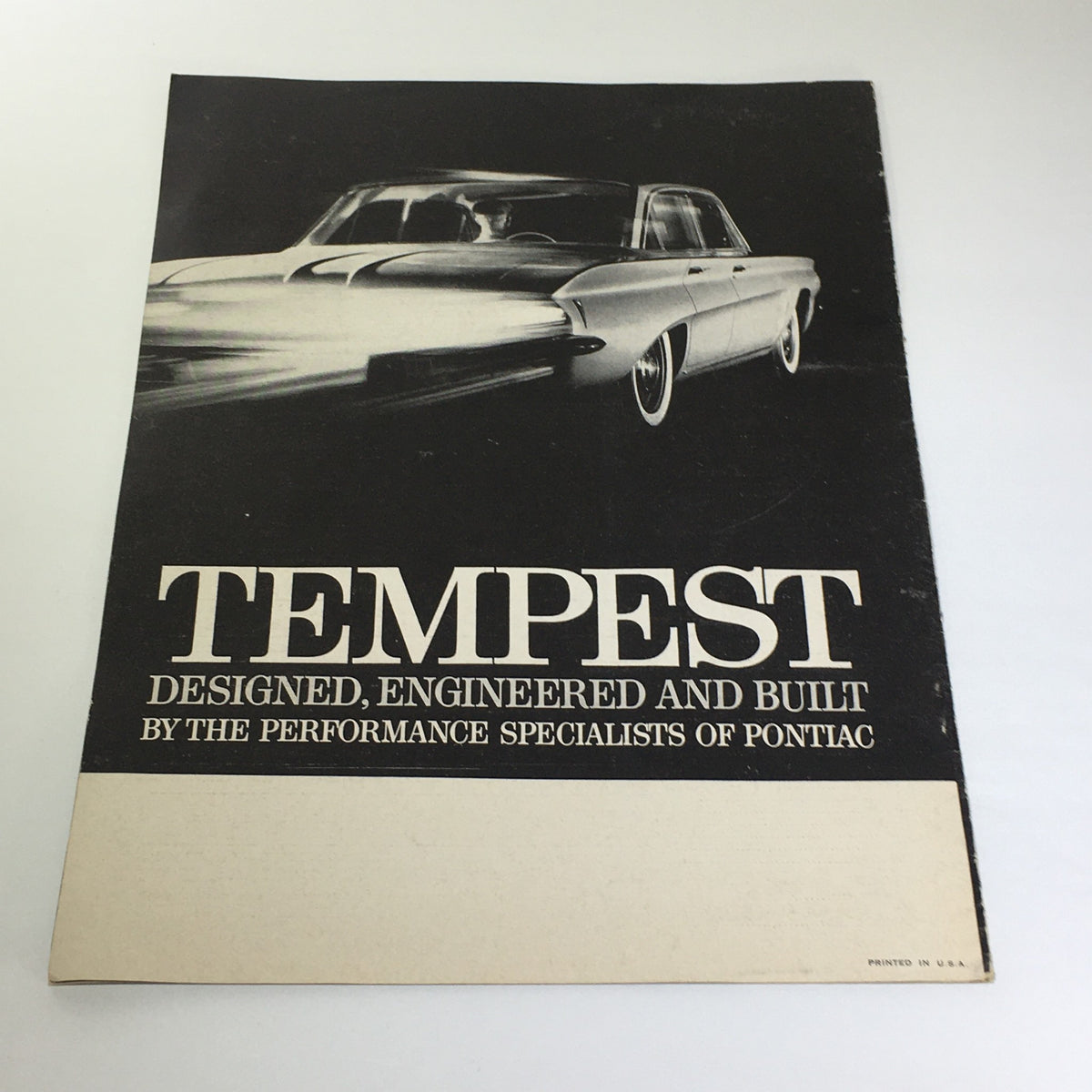 Back cover of the Vintage Pontiac Tempest catalog emphasizing 'DESIGNED, ENGINEERED AND BUILT BY THE PERFORMANCE SPECIALISTS OF PONTIAC' with a classic Pontiac car image.