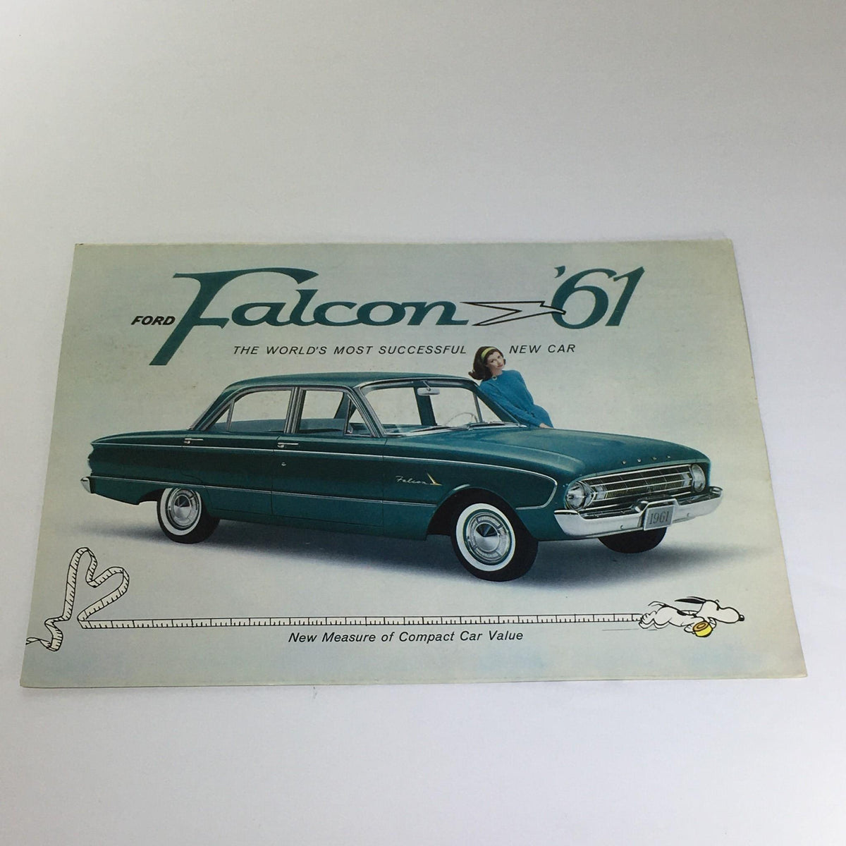 Front cover of Vintage 1961 Ford Falcon Compact Car 2-Door Sedan brochure featuring the car and a model, showcasing its classic design and appeal.
