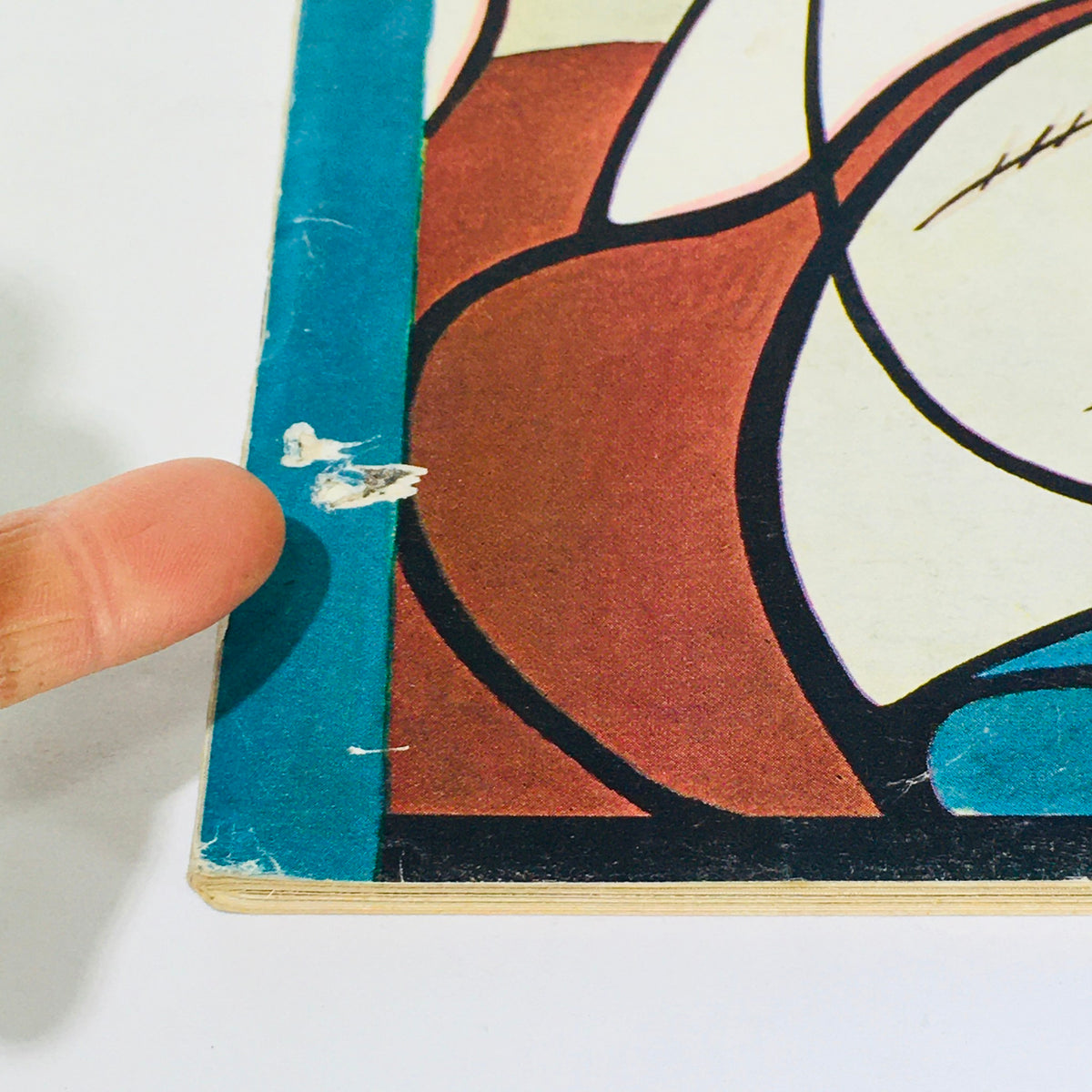 Close-up of the edge of The New Yorker: February 25 1967 magazine, showing wear and a torn area on the cover, indicating it is a used item.