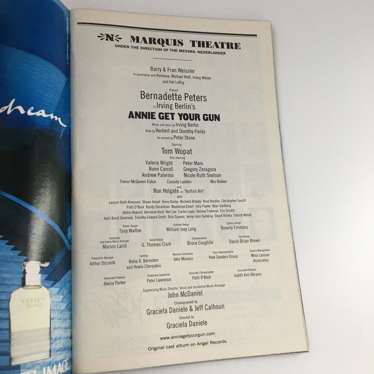 The cast list page from the 1999 Playbill for 'Annie Get Your Gun', showcasing performers such as Tom Wopat, Valerie Wright, and Bernadette Peters with their roles.