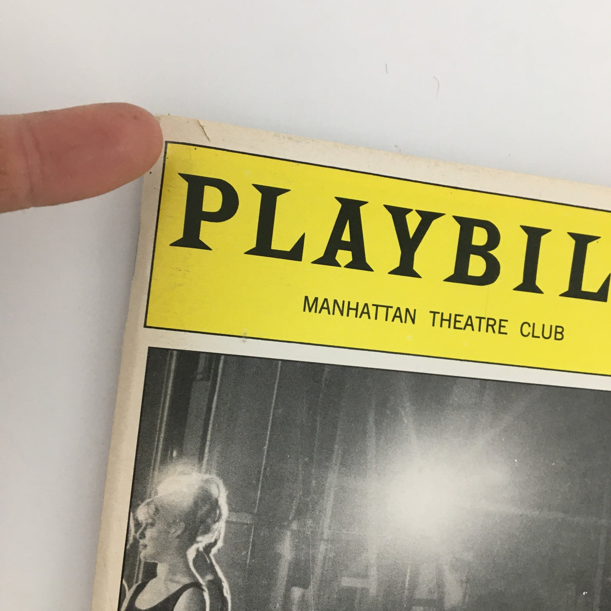 Close-up of the top corner of the 2000 Playbill 'A Class Act' showcasing the Manhattan Theatre Club logo and slight wear.
