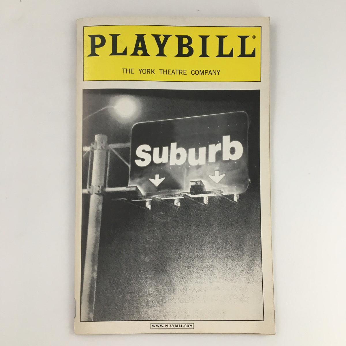 2001 Playbill for the York Theatre Company's production of 'Suburb' featuring a black and white image of a street sign marking the show title.