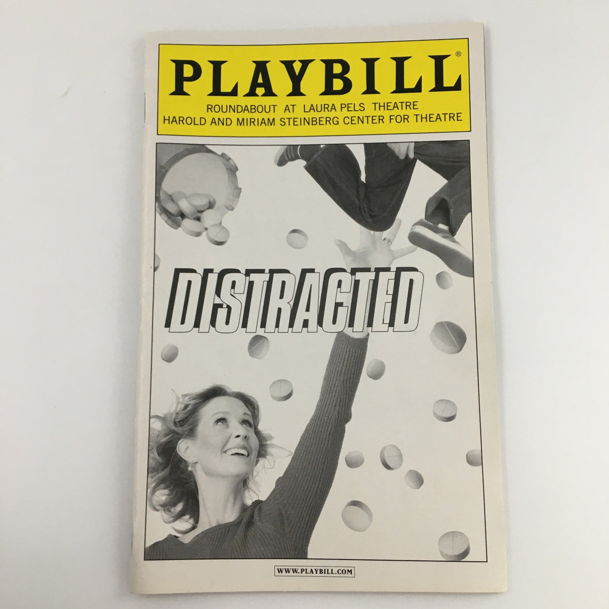 2009 Playbill for Roundabout Theatre Company's production of 'Distracted' featuring a striking black and white cover with an image of an actress juggling balls.