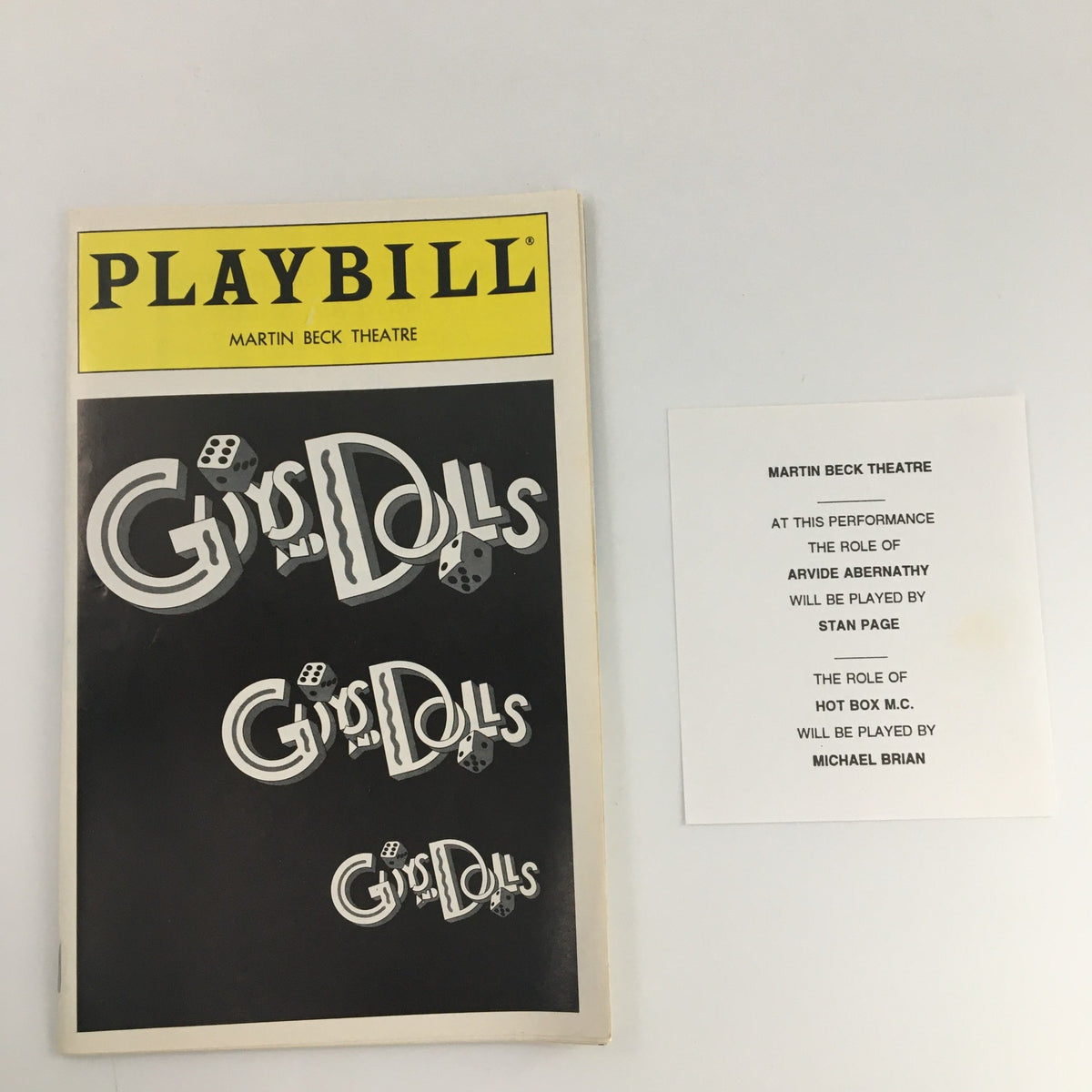 1994 Playbill for Guys and Dolls at Martin Beck Theatre featuring Martin Vidnovic and Kim Crosby, showcasing the cover design with the iconic title and dice graphic.