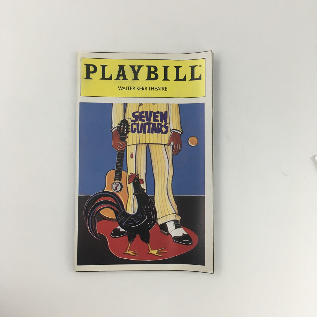 1996 Playbill for the theatrical production 'Seven Guitars' at Walter Kerr Theatre featuring vibrant artwork of a figure in a striped suit holding a guitar, with a rooster at their feet.