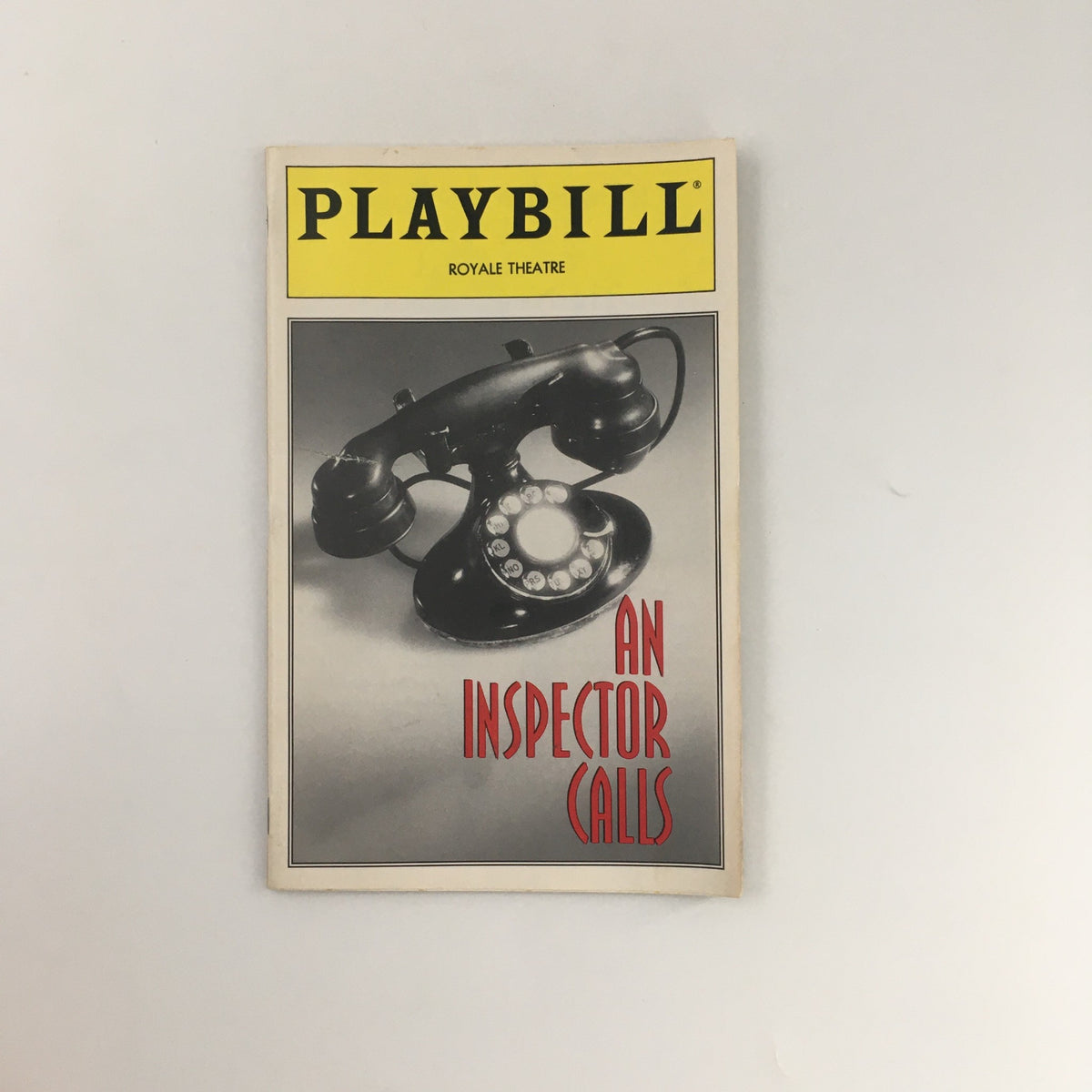 Cover of the 1994 Playbill for 'An Inspector Calls' at the Royale Theater featuring a vintage telephone.