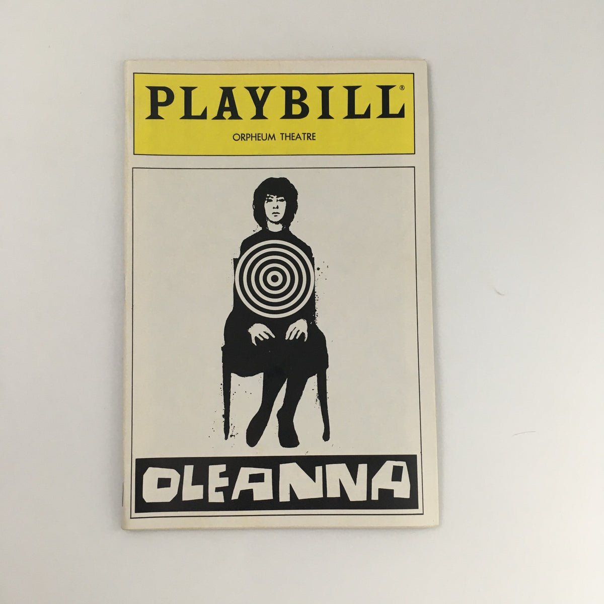 Cover of the 1992 Playbill for 'Oleanna' at the Orpheum Theatre featuring a graphic design of a woman with a target in the center.