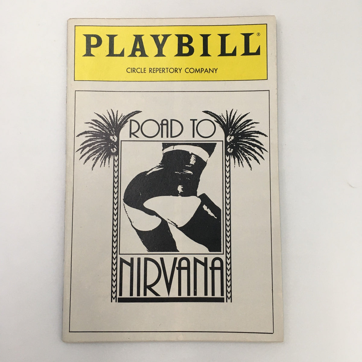 Cover of 1991 Playbill for Circle Repertory Company production 'Road to Nirvana' by Arthur Kopit featuring palm trees and a silhouette design.