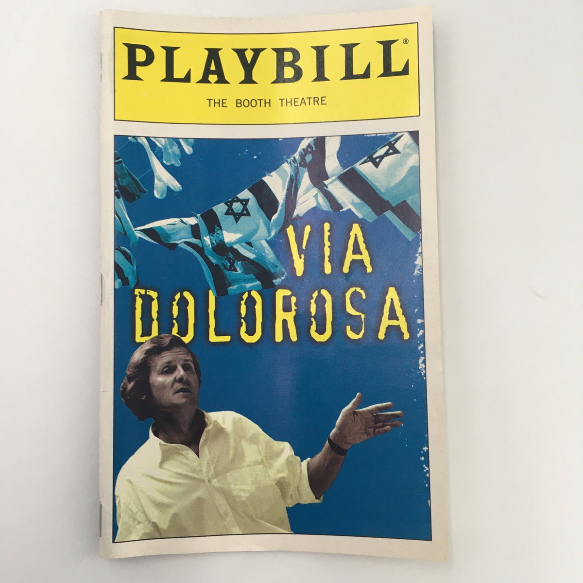 1999 Playbill for 'Via Dolorosa' at the Booth Theatre, featuring David Hare, showcasing vibrant colors and theatrical imagery.