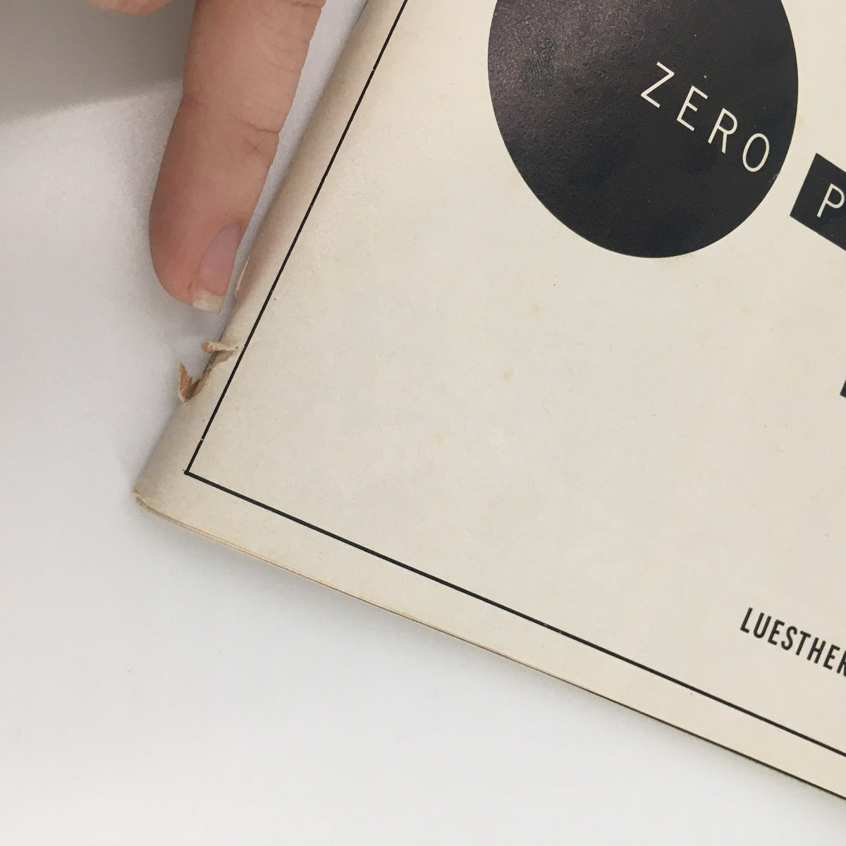 1988 Playbill for the Public Theater’s performance of 'Zero Positive,' showing the cover with a small rip and a finger pointing at it.