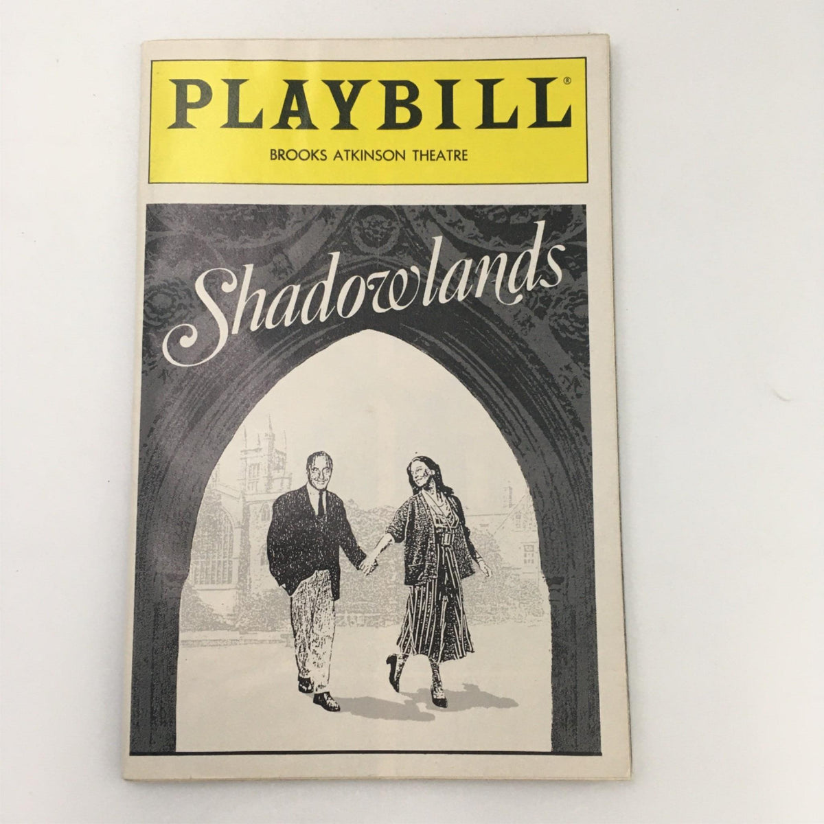 1990 Playbill for 'Shadowlands' at Brooks Atkinson Theatre featuring cover art with characters walking under an arch.