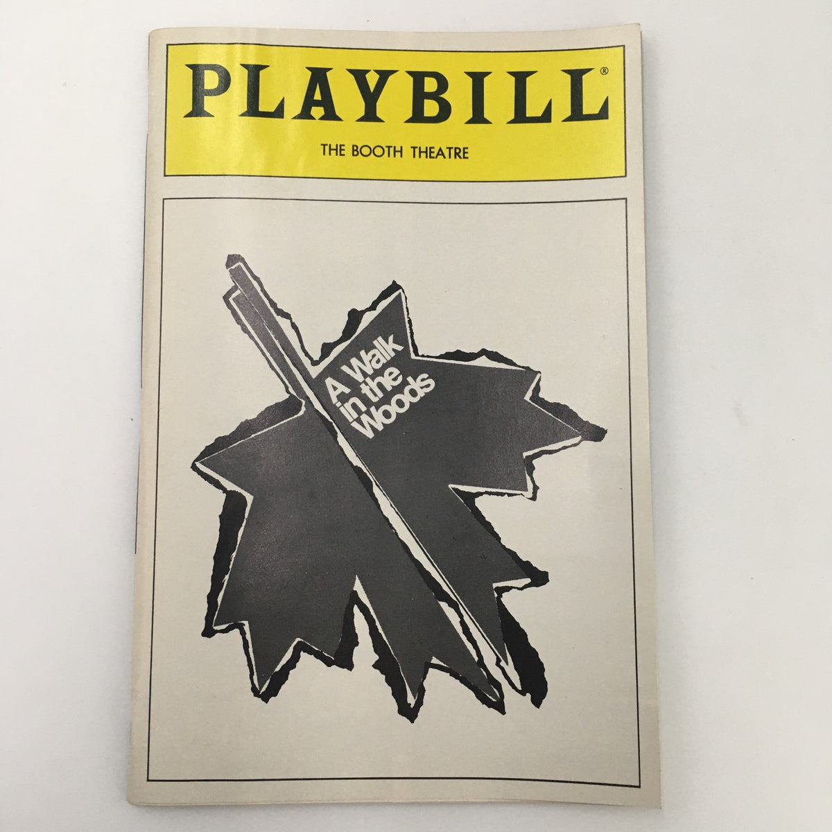 Front cover of the 1988 Playbill from Booth Theatre showcasing 'A Walk in the Woods' by Lee Blessing with a leaf design.
