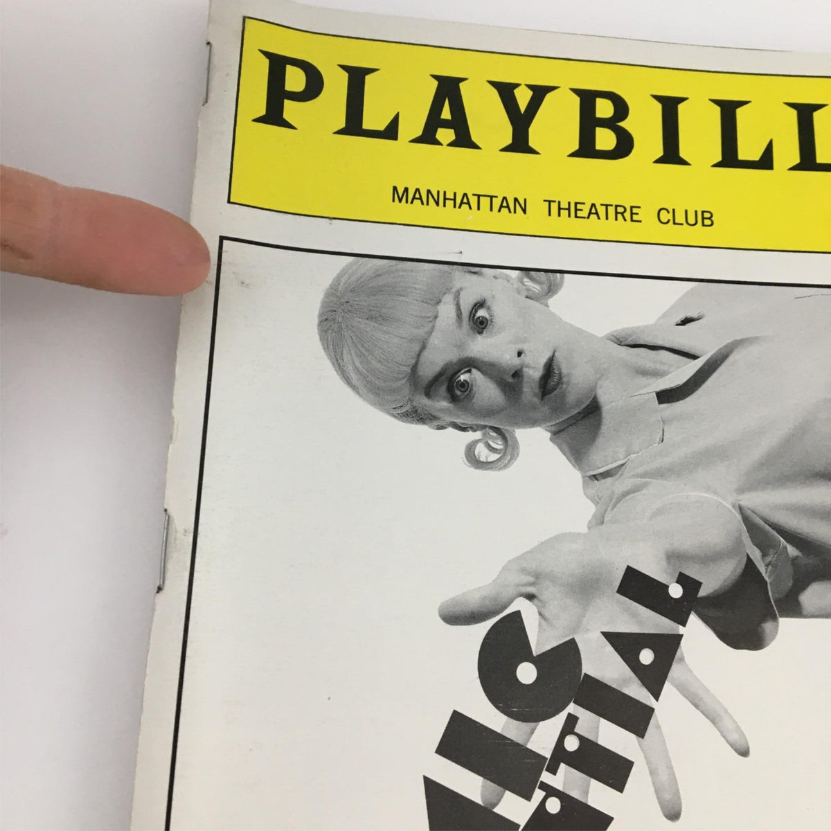 Close-up view of the 2000 Playbill for Comic Potential by Manhattan Theater Club, showcasing minor wear and the character's hand reaching out.